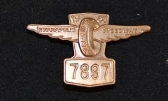 1965 Indy 500 Pit Badge #7897 made by Bastain   Bros., Rochester, NY.  of wing & wheel.