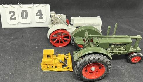 Two Farm Toy Tractors - both newer. One green   Massey-Harris, one gray Fordson on steel  wheels.