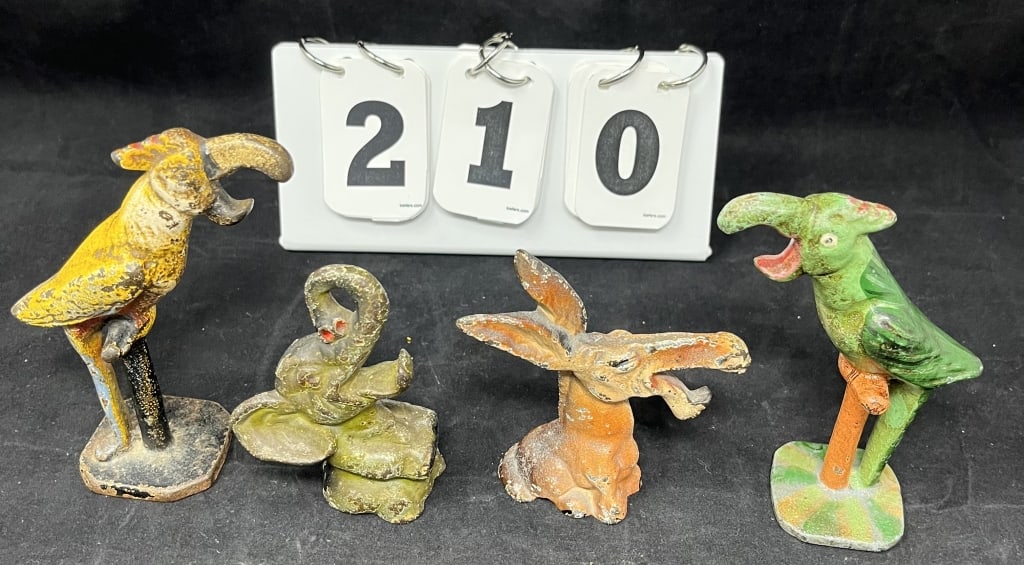 Four Cast Iron Animal Figure Bottle Openers: Two painted Tuscan Parrots on a perch, Hubley donkey: Four Cast Iron Animal Figure Bottle Openers: Two painted Tuscan Parrots on a perch, Hubley donkey has original paint, Hubley baby elephant. 5" x 3" x 2"