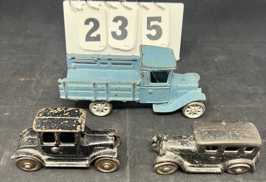 Three Cast Iron Arcade Toys : Blue stake bed   truck 3" x 7" x 3"  , two door sedan, 4 door   sedan. (1 of 7)