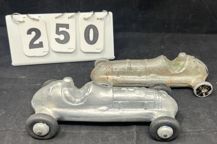 Two Playmate Cast Aluminum, 1940's Race Car  one on  rubber wheels w/ star on hood, one  has a bit