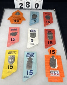 Group of  9  Indy 500 Pit Pass Badges w/  Backers  including: 1979 #5558 silver on  orange backer,