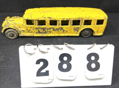 Arcade Yellow Bus older flaking paint green  under  yellow on rubber wheels. No driver.    3" x 12"