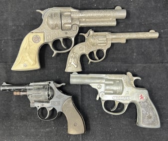 Four die cast metal cap guns: Texan ,  Trooper,  Black 22 cap revolver, Smaller  Texan  6" x 2" x 4"