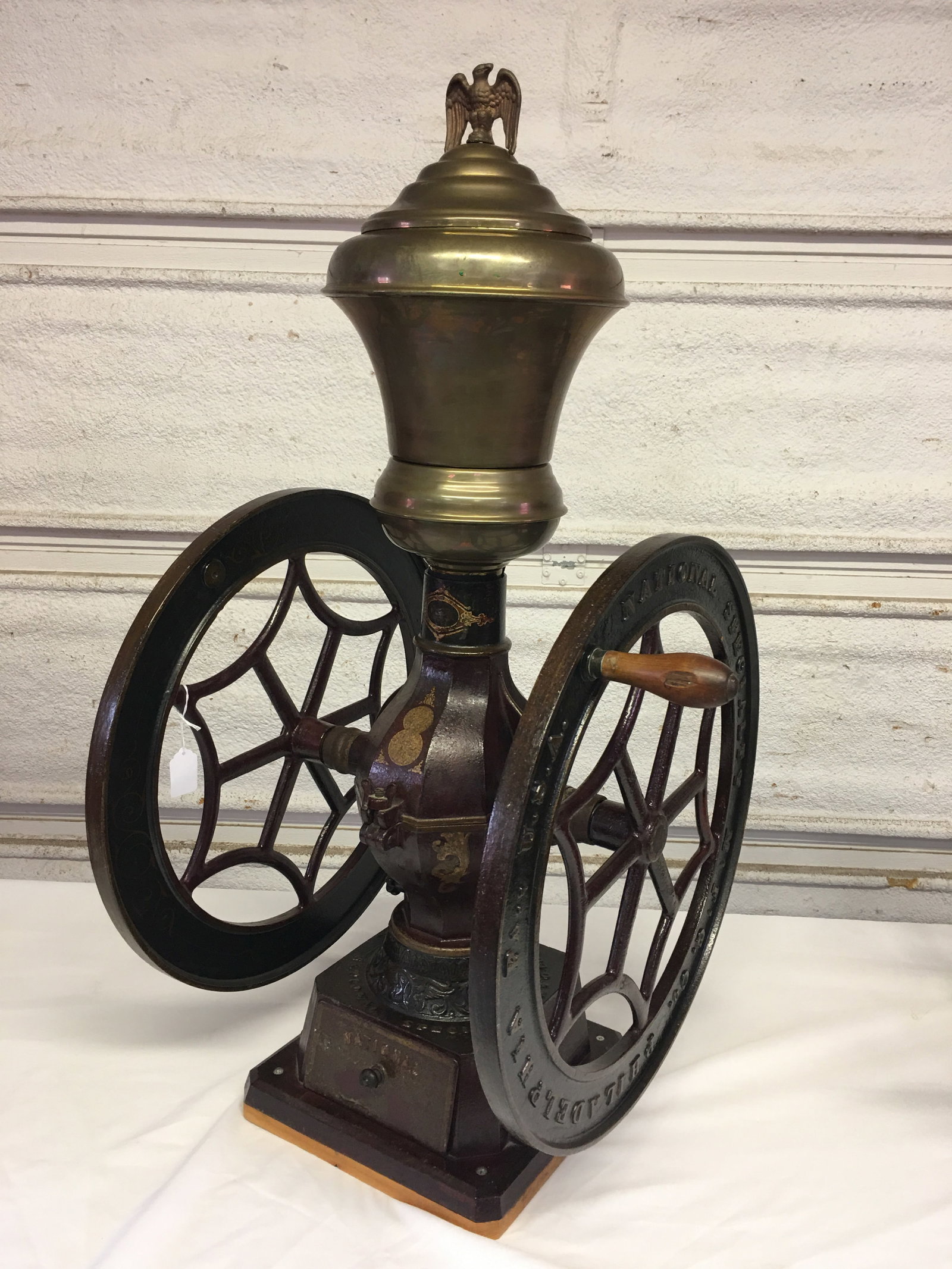 National Specialty #10 Coffee Grinder: National Specialty #10 Upright Coffee Grinder. Rare 20" double flywheels with a nickel plated hopper & eagle. Original cranberry, hunter green and gold paint. All original decals! Wheels marked "Natio