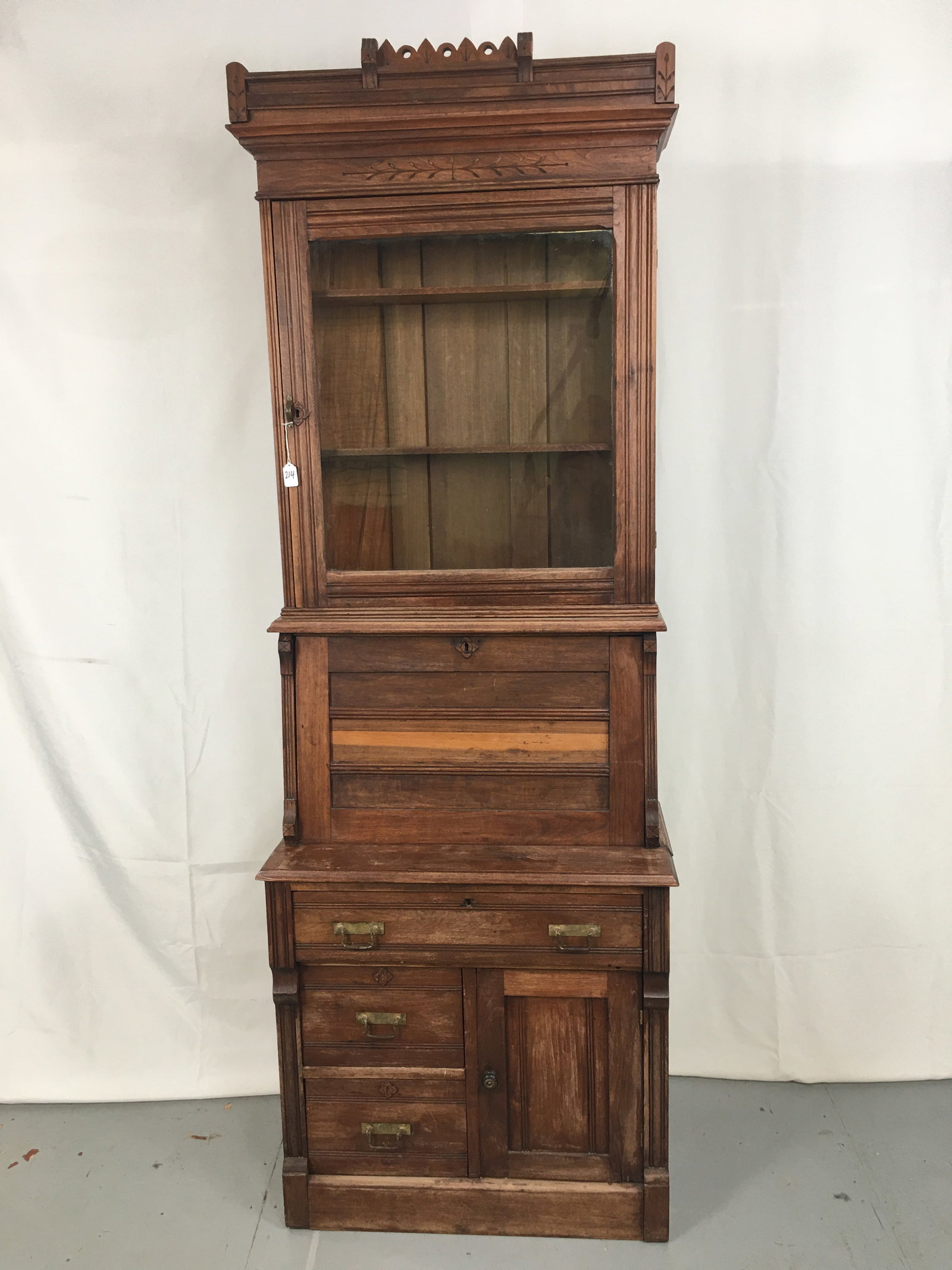 Eastlake Secretary Bookcase: Eastlake Secretary Bookcase. Two pieces. Drop front desk with cubbies, drawer & green felt writing surface. Upper glass door bookcase; lower section with two drawers and a door. 30"W x 16.5"D x 85"H