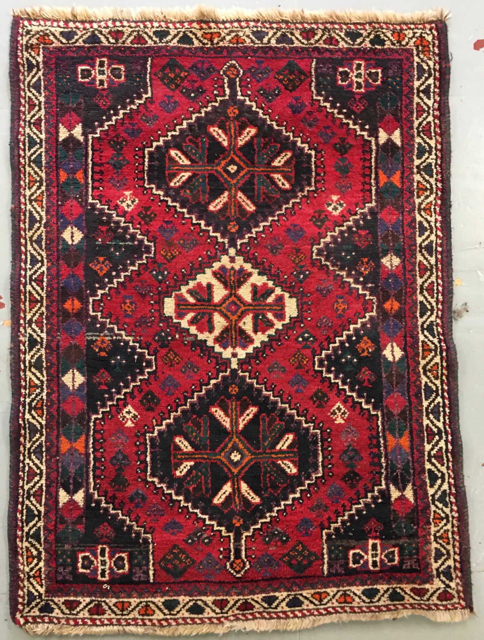 Handwoven Shiraz Rug: Handwoven Shiraz Vegetable Dye deep red, blues, & earth tones. Geometric patterns w/ central medallion & smaller geometric motif & bond border. Wool dense pile. Nomadic. 4'5" x 62"
