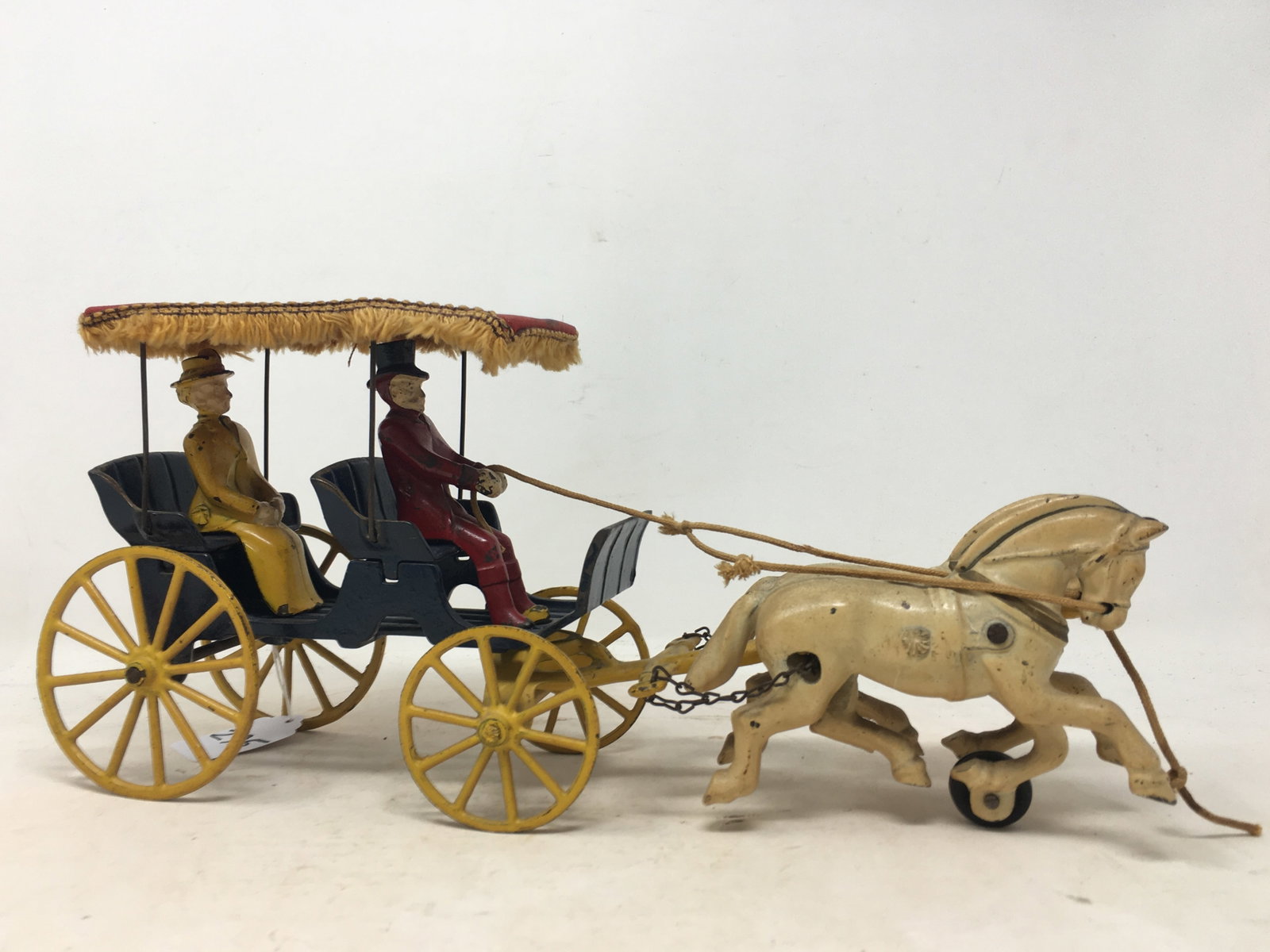 Kenton Cast Iron Horse Drawn Surrey: Kenton Cast Iron Horse Drawn Surrey, Fabric Top With Fringe. Man Driver & Lady Passenger. Horses have rope bridles. 13"L x 3.5"W x 6"H