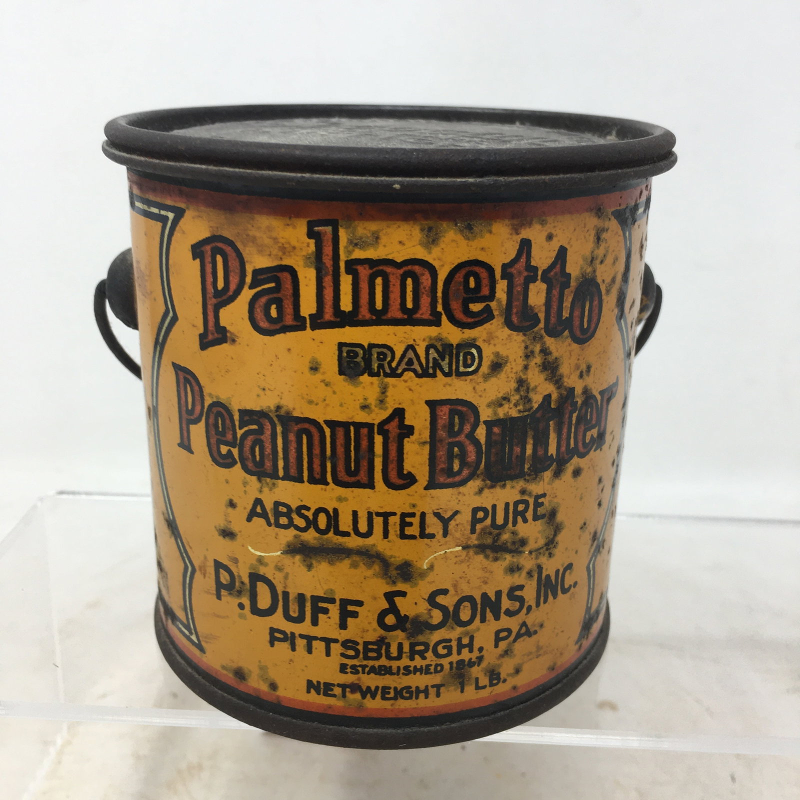 1 Lb. Palmetto Peanut Butter Tin: 1 Lb. Peanut Butter Tin, Palmetto Brand Peanut Butter, P. Duff & Sons, Inc., Pittsburgh, PA, Established 1867. 3.5"W x 3.5"H