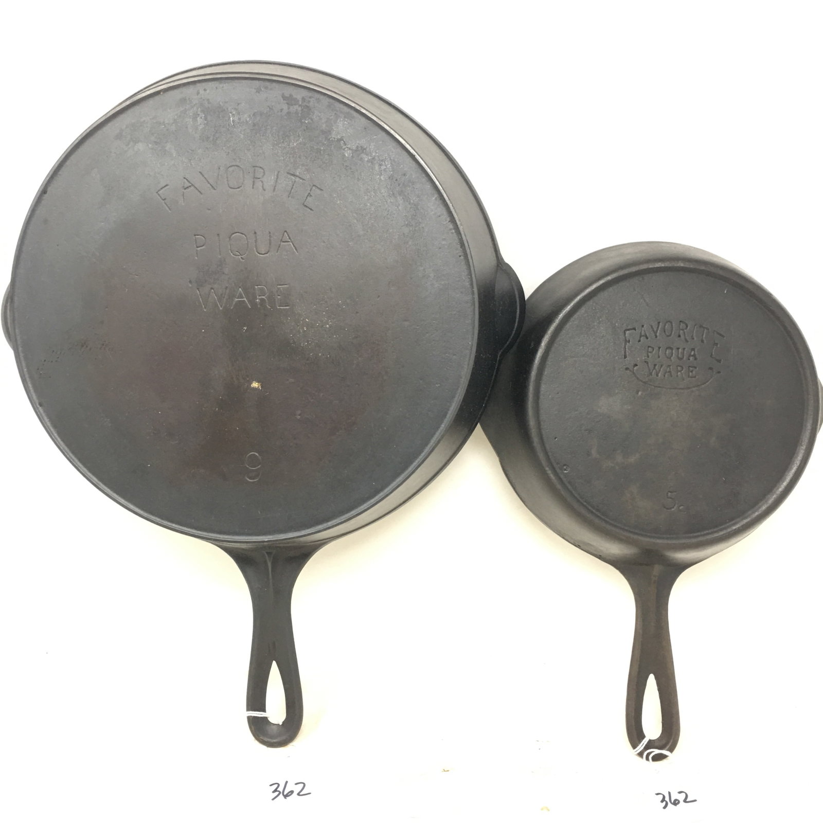 Favorite Piqua Ware No. 5 & No. 9 Skillets: (2) Favorite Piqua Ware Cast Iron Skillets. Both with heat rings. 1) #9 Skillet, 16"L x 12.25"W x 2.5"H. 2) #5 Skillet, 12.5"L x 8.5"W x 2"H