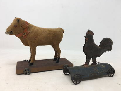 Bull & Rooster Pull Toys: 1) Bull Pull Toy on wooden platform. Cloth covered, ring in nose, collar around neck. 7"L x 2.5"W x 5"H'; 2) Tin Rooster Pull Toy on Blue Base. Red comb and wattle. 5"L x 1.75"W x 4.5"H
