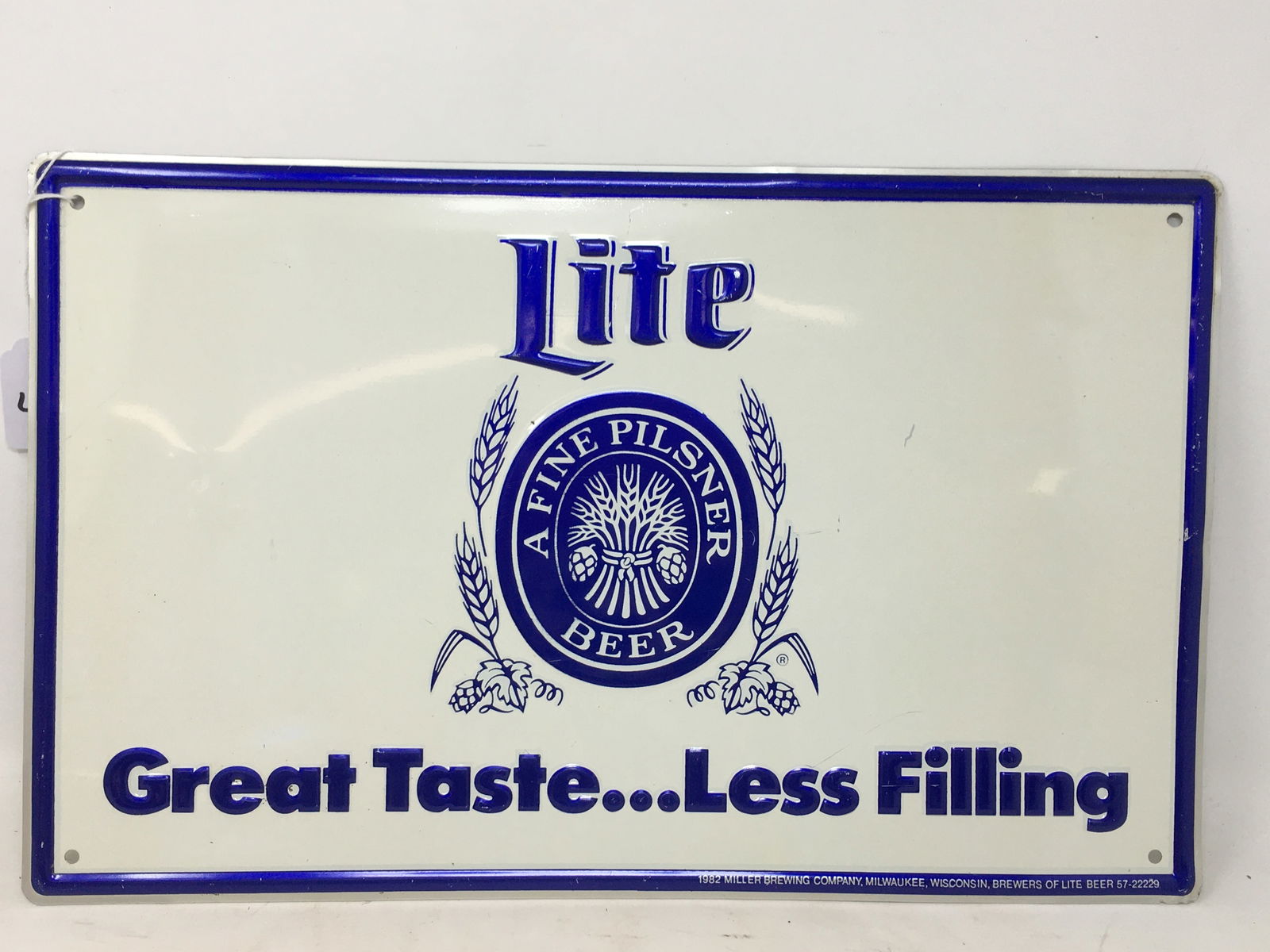 Vintage Miller Lite Beer Embossed Sign: Vintage Miller Lite Beer Advertising Sign. Embossed "Lite, Great Taste…Less Filling". 1982 Miller Brewing Company, Wisconsin, Brewers of Lite Beer 57-22229. 16"L x 10"H