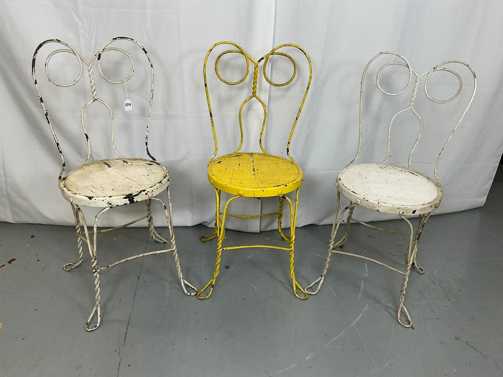 (3) Ice Cream Parlor Chairs: (3) Ice Cream Parlor Chairs. 2 white, 1 yellow. Each 17"W x 17"D x 34"H