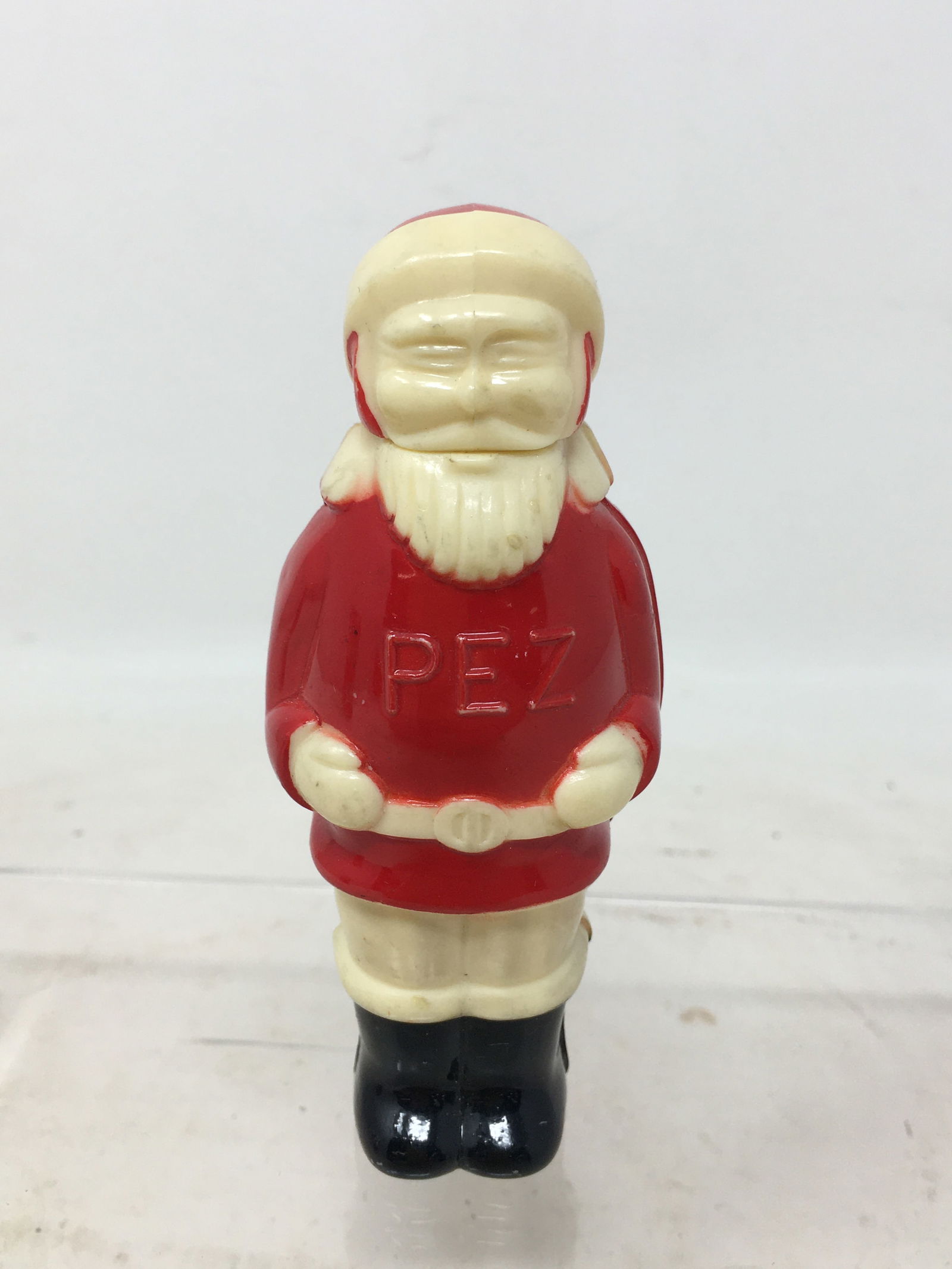 Full Bodied Santa Pez Dispenser: Vintage Full Bodied Santa Claus Pez Dispenser. Black boots, White pants, Red Coat & Hat. "PEZ" on chest, Made in Austria on back of boot. Slight paint wear to one side of hat, otherwise very good. 1.5