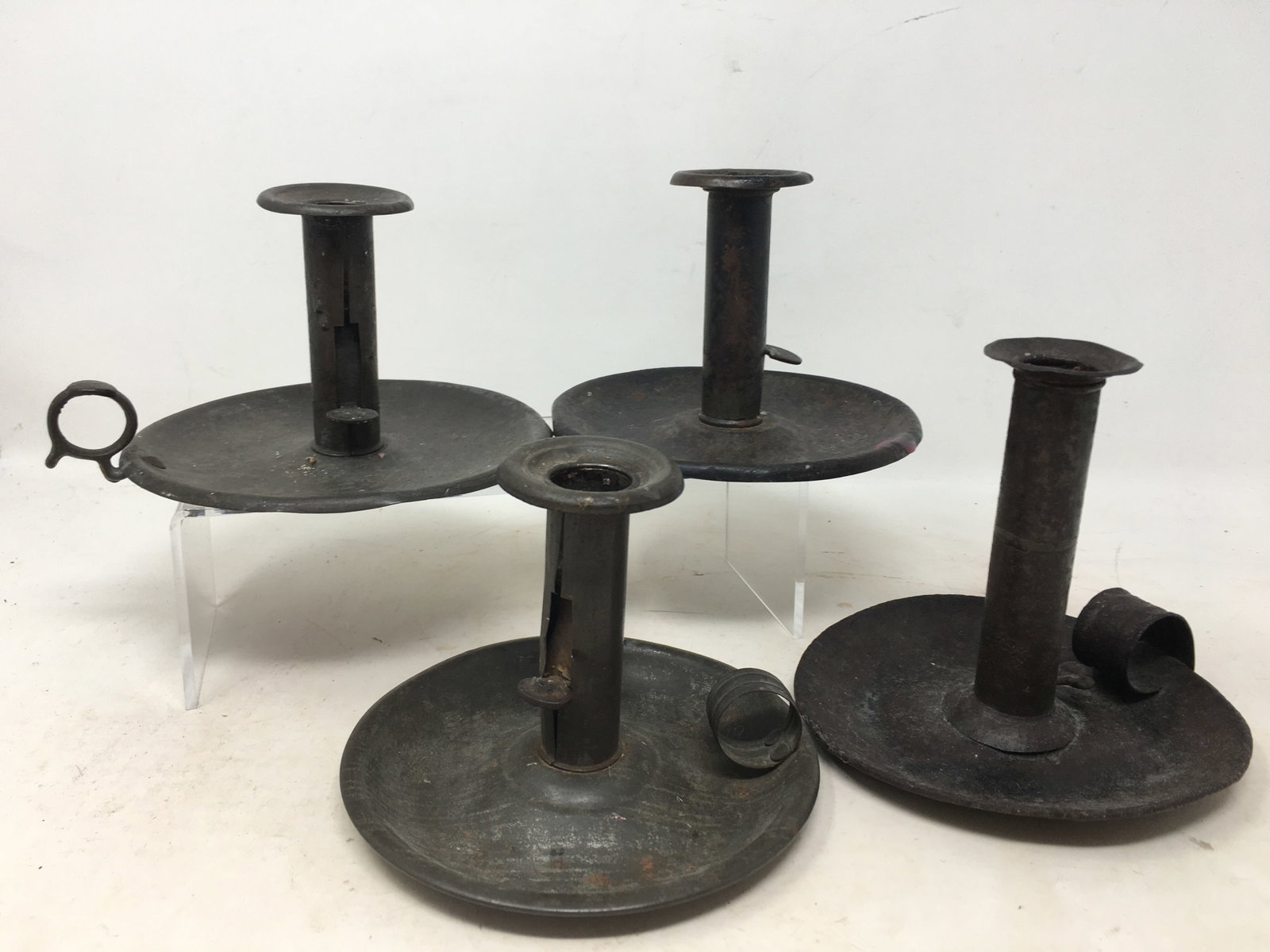 4 Adjustable Tin Chambersticks: (4) Adjustable Tin Chambersticks or Candle Holders. (3) have finger holds. Largest 6.5"W x 3.5"H