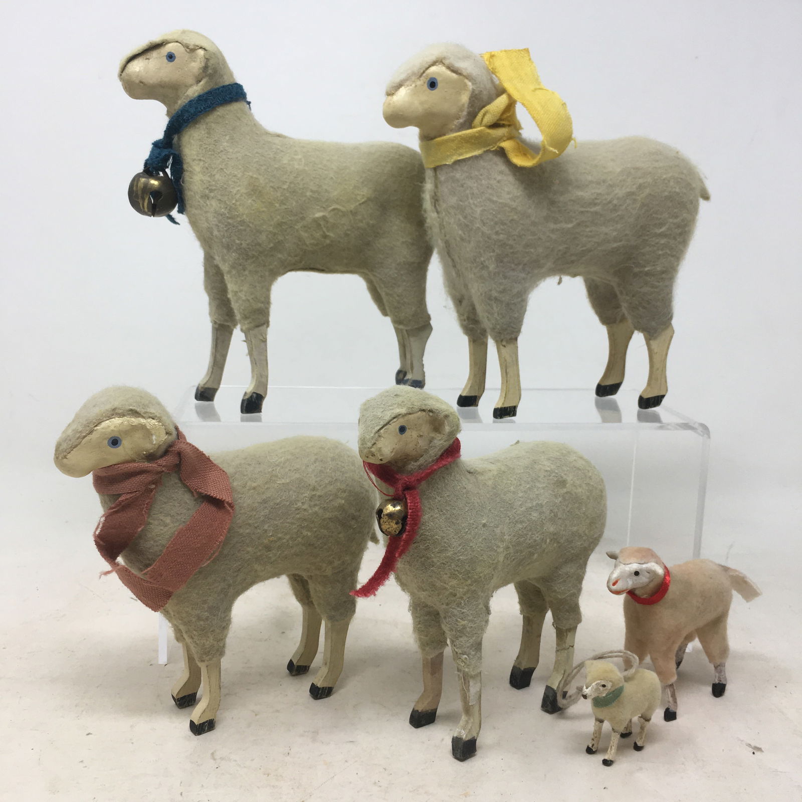 (4) German Putz Stick Leg Sheep: (4) German Putz Stick Leg Sheep. One sheep has repaired leg. Also a stick leg lamb and a metal stick leg sheep ornament. Largest 5.5"L x 1.75"W x 5.5"H