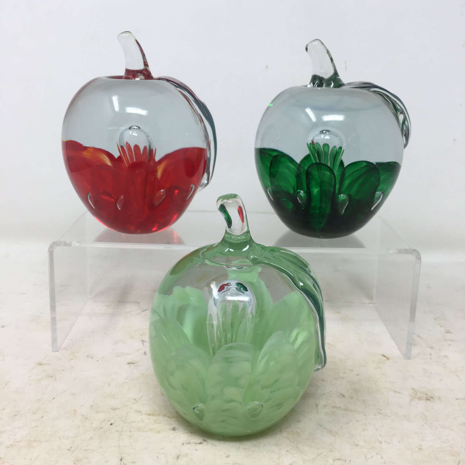 (3) St. Clair Art Glass Apple Paperweights: (3) St. Clair Art Glass Apple Paperweights. Red marked St. Clair, dark green marked St. Clair, light green unmarked. Largest 3"W x 4.25"H