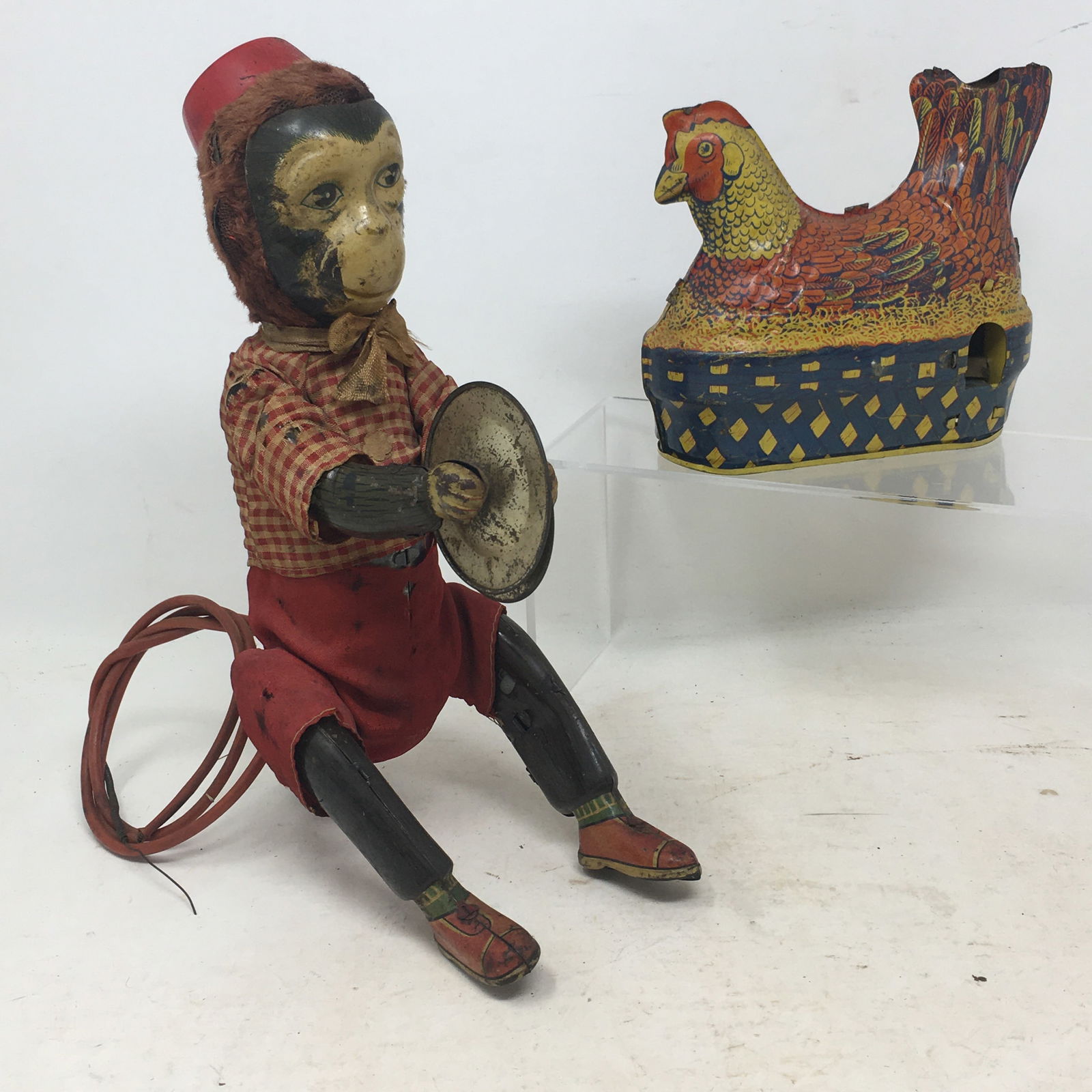 Tin Litho Toys, Monkey & Little Red Hen: (2) Tin Litho Toys. 1) Mechanical cymbal-playing monkey. Tin body with fur covered head. Wear to fur & clothing. 5.5"W x 9"H. 2) Baldwin Little Red Hen, no eggs. 5.25"L x 2.5"W x 3.5"H