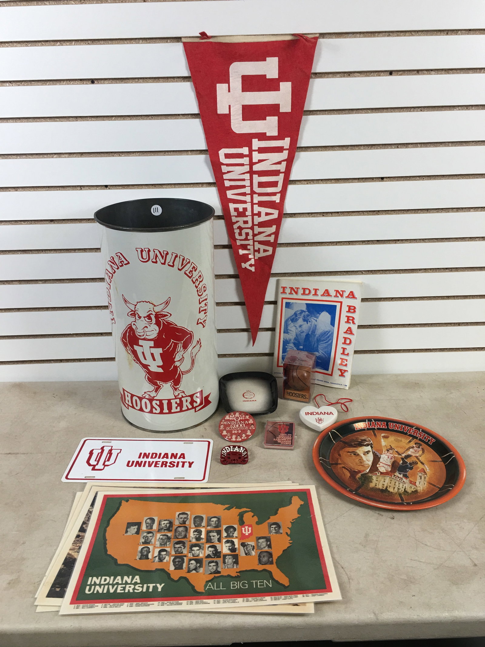 Group of Indiana University Memorabilia: Group of Indiana University Memorabilia. Incl. 1978 Indiana Bradley Official Sports Magazine; metal trash can, 19.5"H; felt pennant, 1976 NCAA Basketball National Champs Coke tray; 80-81 NCAA
