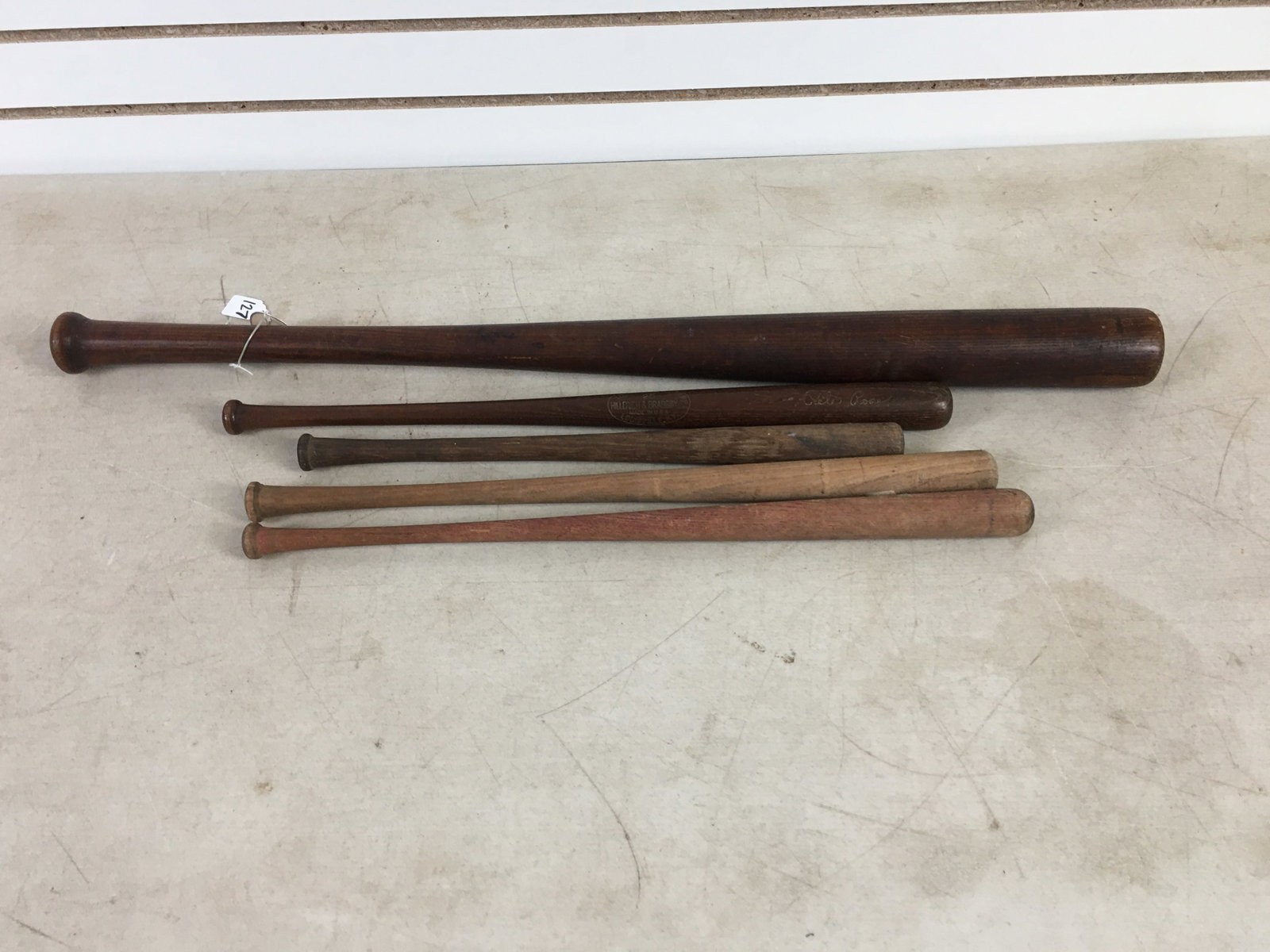 (5) Wooden Baseball Bats: (5) Wooden Baseball Bats. Largest marked Logan, 33.5". 2 miniatures marked, one with Lafayette, Ind.; other Louisville Slugger, 25, Hillerich & Bradsby Co.