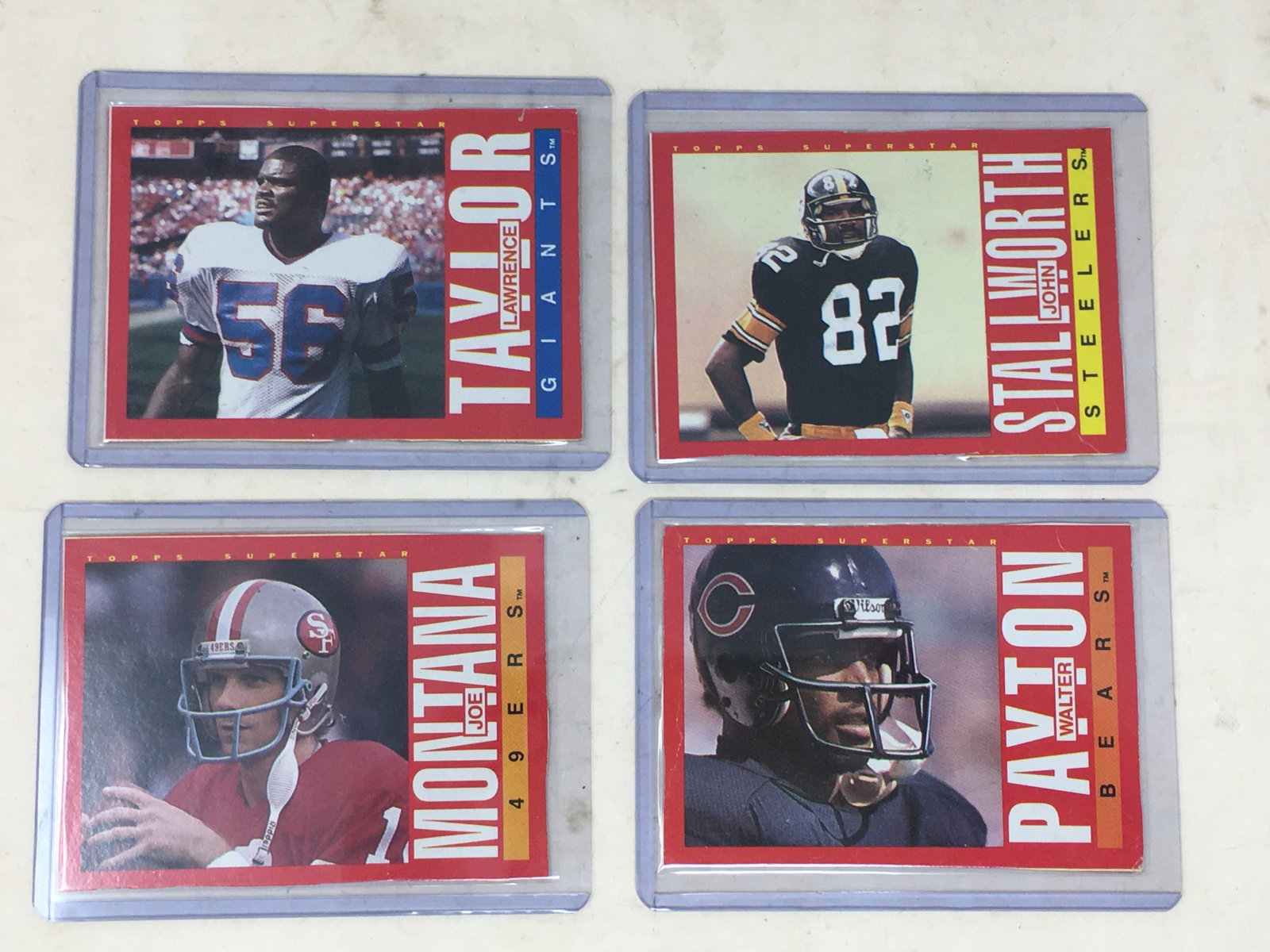 (4) 1985 Topps Box Bottoms, Hand Cut: (4) 1985 Topps Box Bottoms Football Cards, Hand Cut. M (Joe Montana); N (Walter Payton); O (John Stallworth); P (Lawrence Taylor)