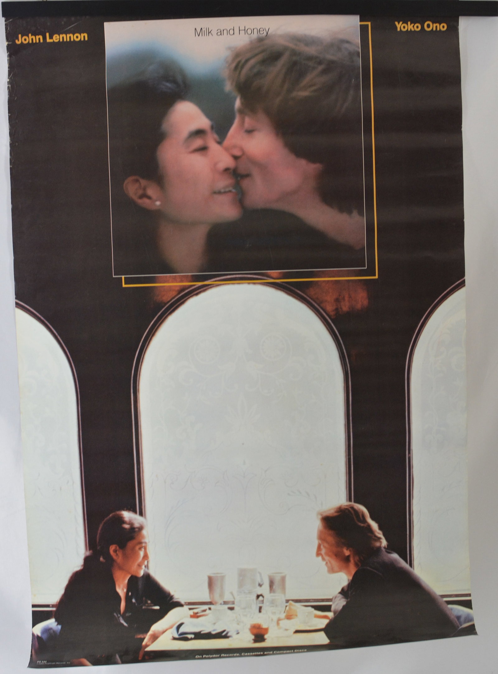 John Lennon & Yoko Ono "Milk and Honey" Promotional Poster: Vintage promotional poster for "Milk and Honey" by John Lennon and Yoko Ono, featuring photographic images of the couple including the album artwork and cafe scene composition. Music memorabilia poste