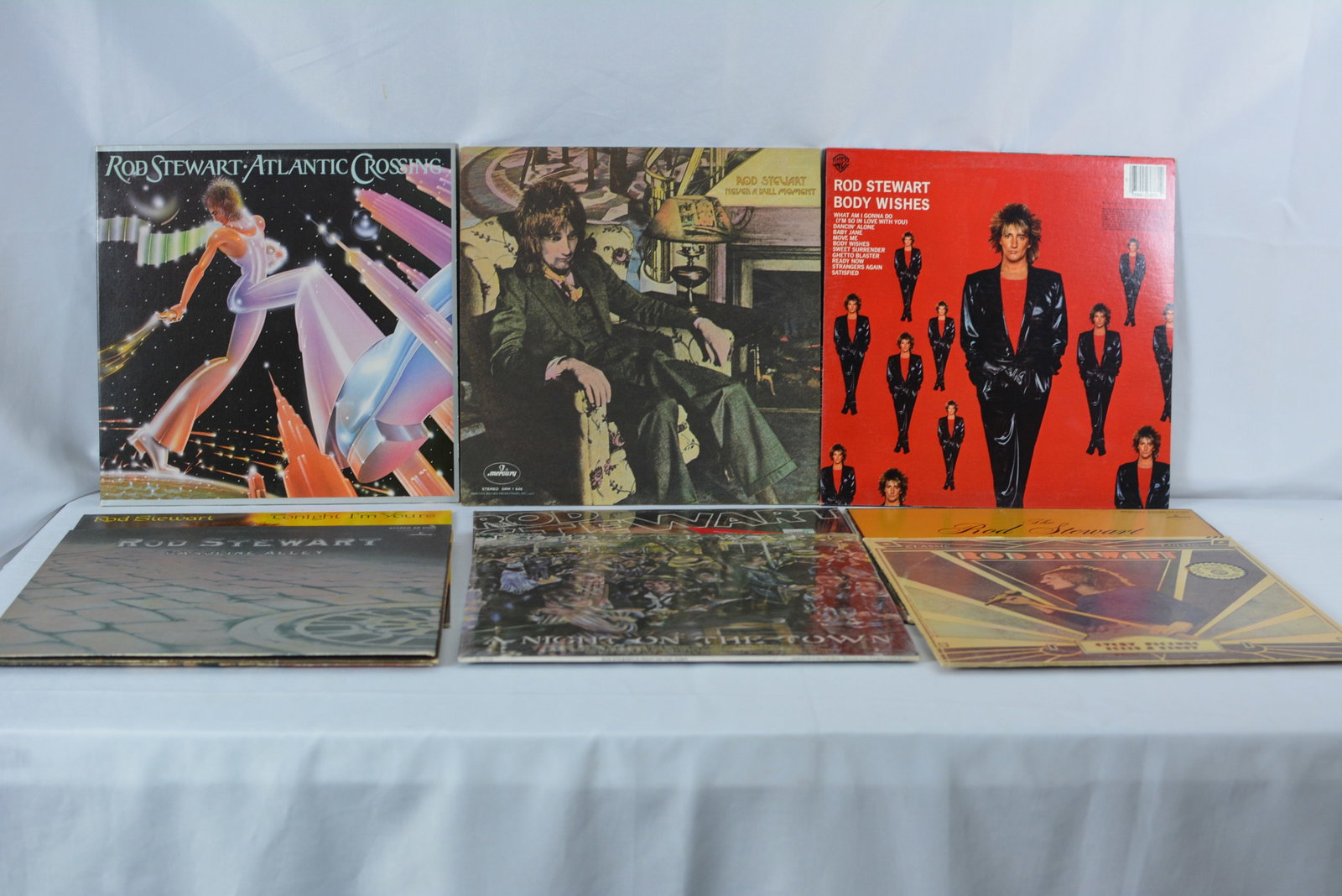 Rod Stewart Vinyl Record Collection (8 LPs + Posters/Inserts): Collection of vintage LP records by Rod Stewart spanning the 1970s and 1980s. Includes several classic albums, compilation releases, and original inserts/posters. Great lot for classic rock collectors