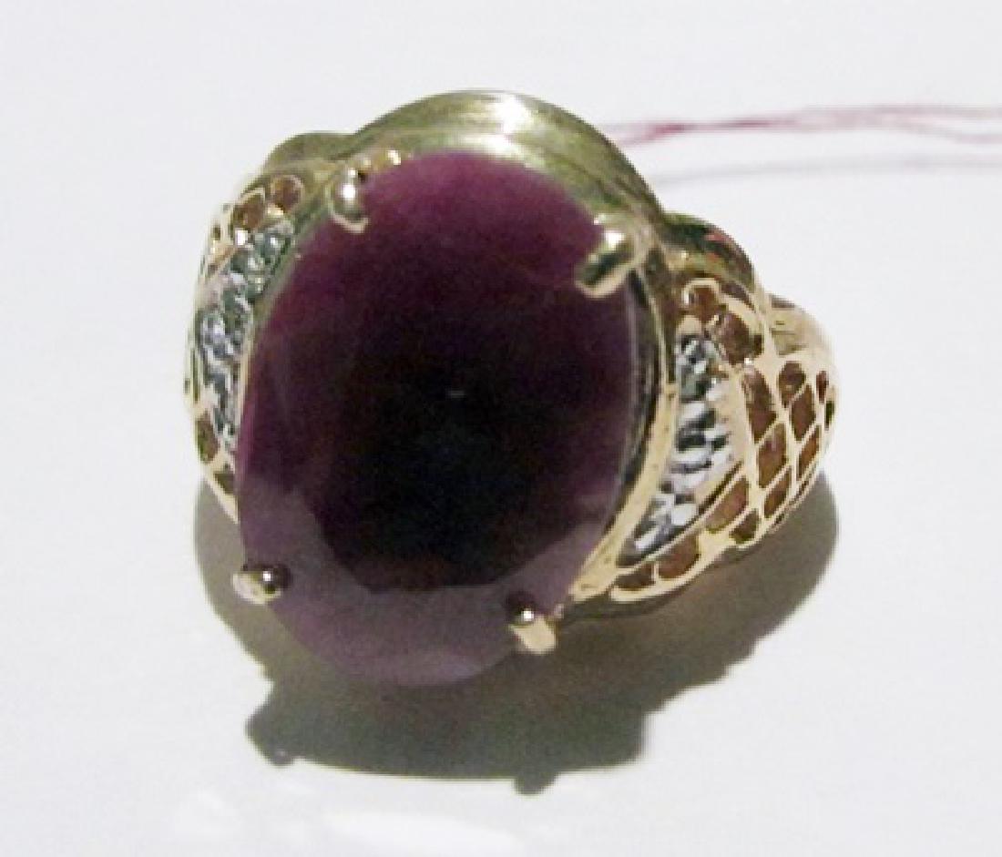 10K Yellow Gold Ruby & Diamond Ring: This 10K yellow gold ruby & diamond ring is comprised of 4 prongs set oval cut ruby surrounded by 4 prongs set 6 round diamonds. This estimated weight of the ruby is 3.25ctw. This estimated weight of