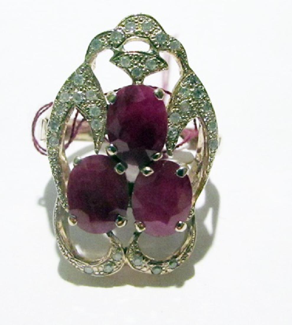 10k Yellow Gold Ruby & Diamond Ring: This 10K yellow gold rubbies/diamonds ring is comprised of 4 prongs set oval cut rubbies surrounded by 4 prongs set 32 round diamonds. This estimated of the amenthyst 4.50cts. This estimated weight of