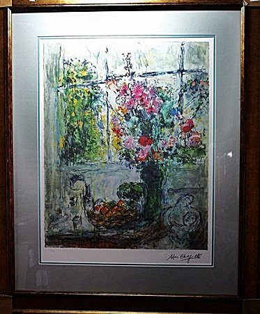 By Chagall "Bouquet w/fruit" Ltd. Ed. Lithograph (2022): By Marc Chagall lithograph. Published in Paris circa, measuring approx. 40x31 with very good margins. The work is framed and matted in very good condition. Signed and numbered.