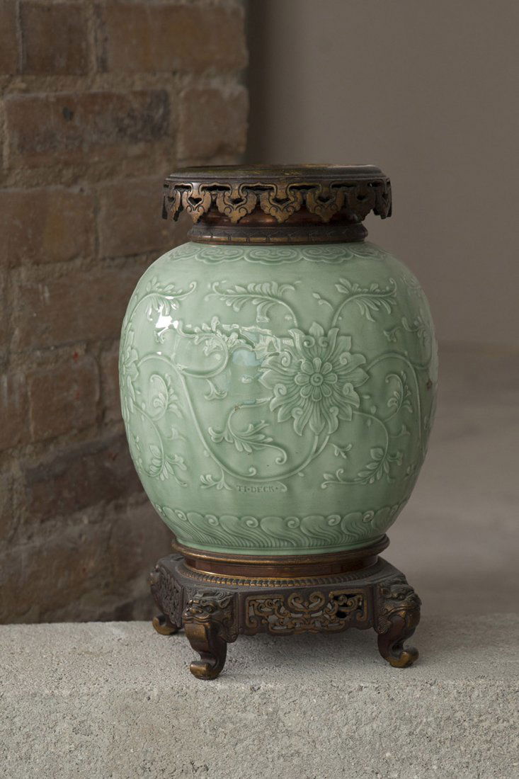 Theodore Deck (1823-1891) Vase: En faience emaillee celadon a decor floral en relief, monture en bronze dore japonisant Signe An earthenware celadon vase with a low relief decoration of flowers, gilt bronze mounts, signed H. 32 cm C