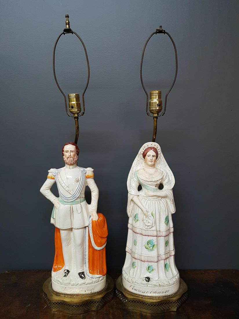 Large Staffordshire Royal Figurines Lamps: Large Staffordshire Royal Figurines Table Lamps, Duke and Duchess of Edinburgh Some loss to paint, missing shades Figurines measure approx 17 inches, lamps including harps measure approx 31 inches. La