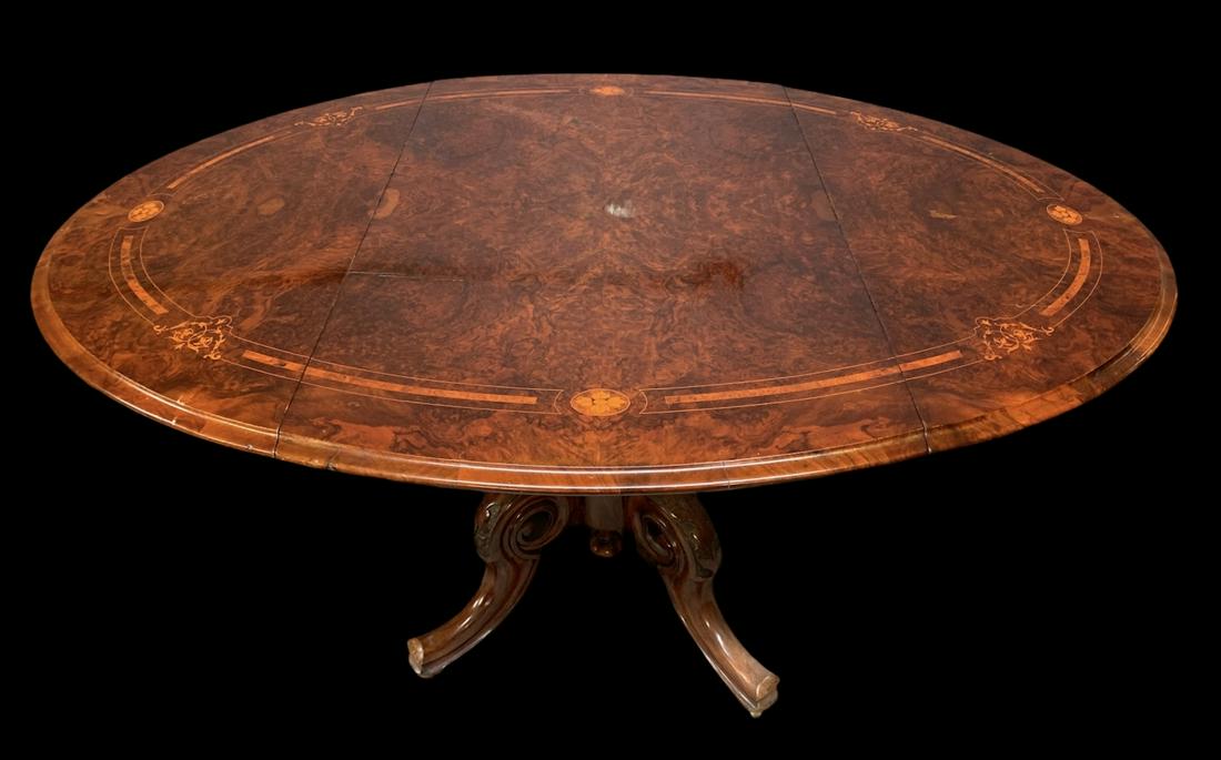 Victorian Burl Walnut Inlaid Drop Leaf Oval Table: Victorian Burl Walnut Inlaid Drop Leaf Oval Top Table. Carved Base On Porcelain Casters. Watermark To Center Of Table Top. Table Measures 29 H X 42 X 24 (58 Inches Fully Extended).
