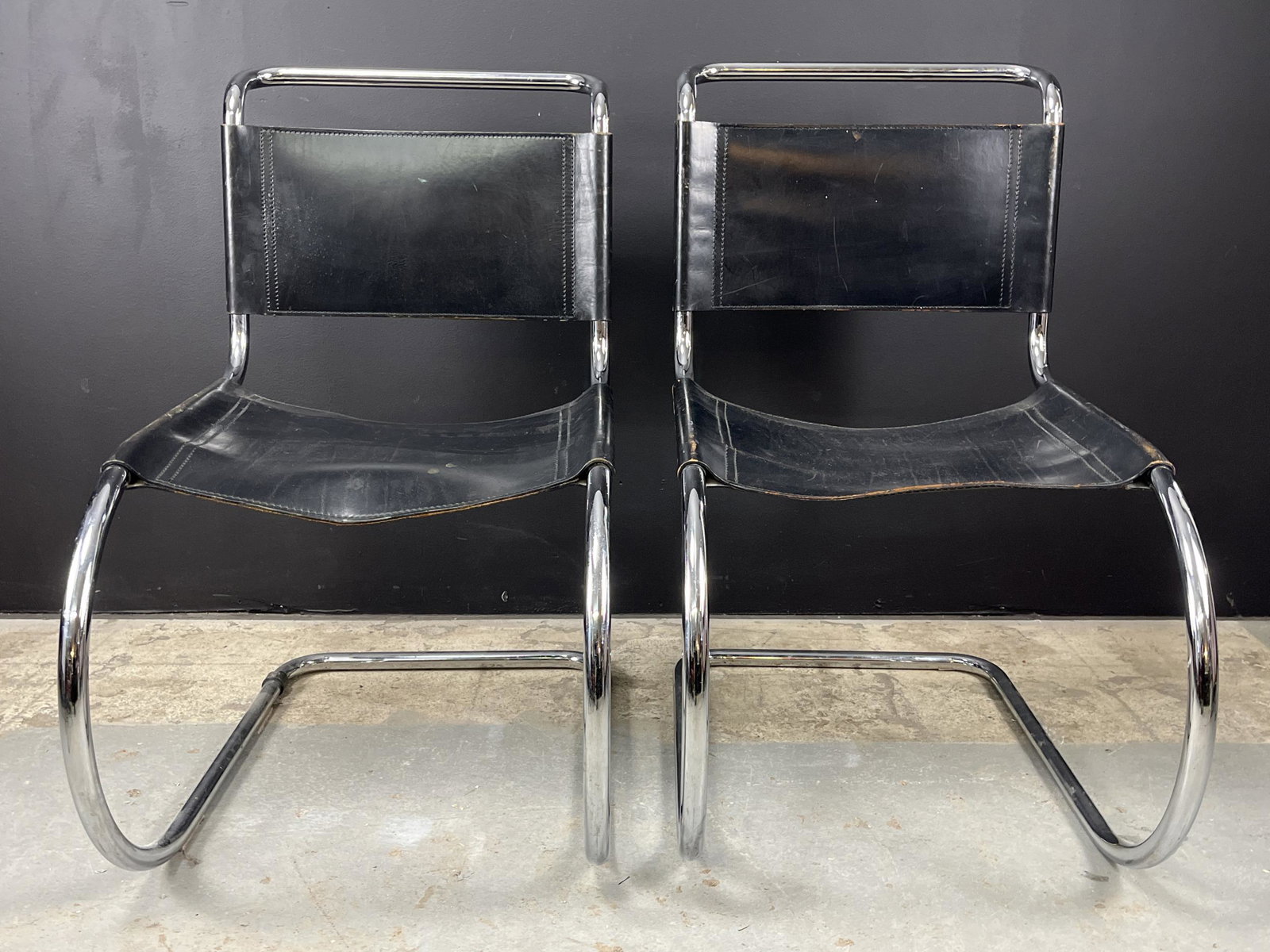 Fasem Mies Van Der Rohe Original Mr10 Chairs: Fasem Mies Van Der Rohe Original Mr10 Chairs. Pair Of Black Leather And Chrome Chairs. Overall Good Vintage Condition, Small Split To Leather On The Underside Of The Seat Of One Chair. 34h X 27d X 19w