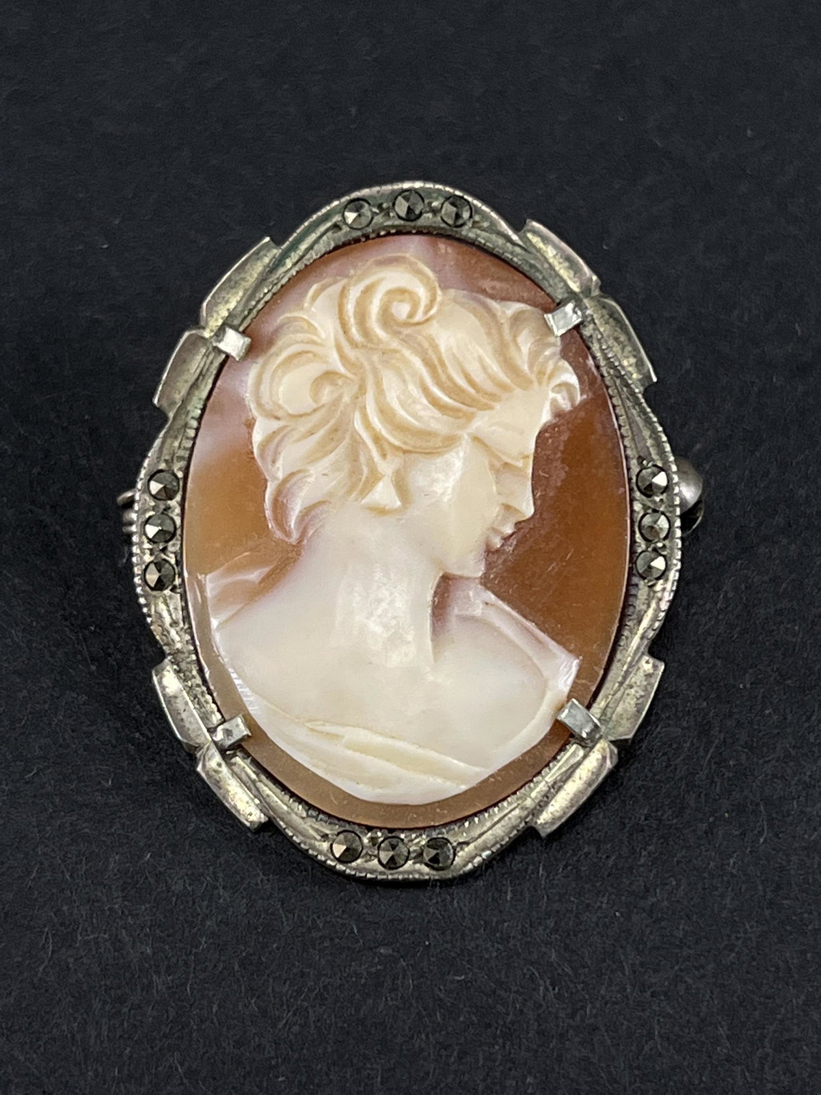 Silver and Marcasite Carved Cameo Brooch: Silver and Marcasite Carved Cameo Brooch. Marked 925. 1.25 inches L x 1 W.