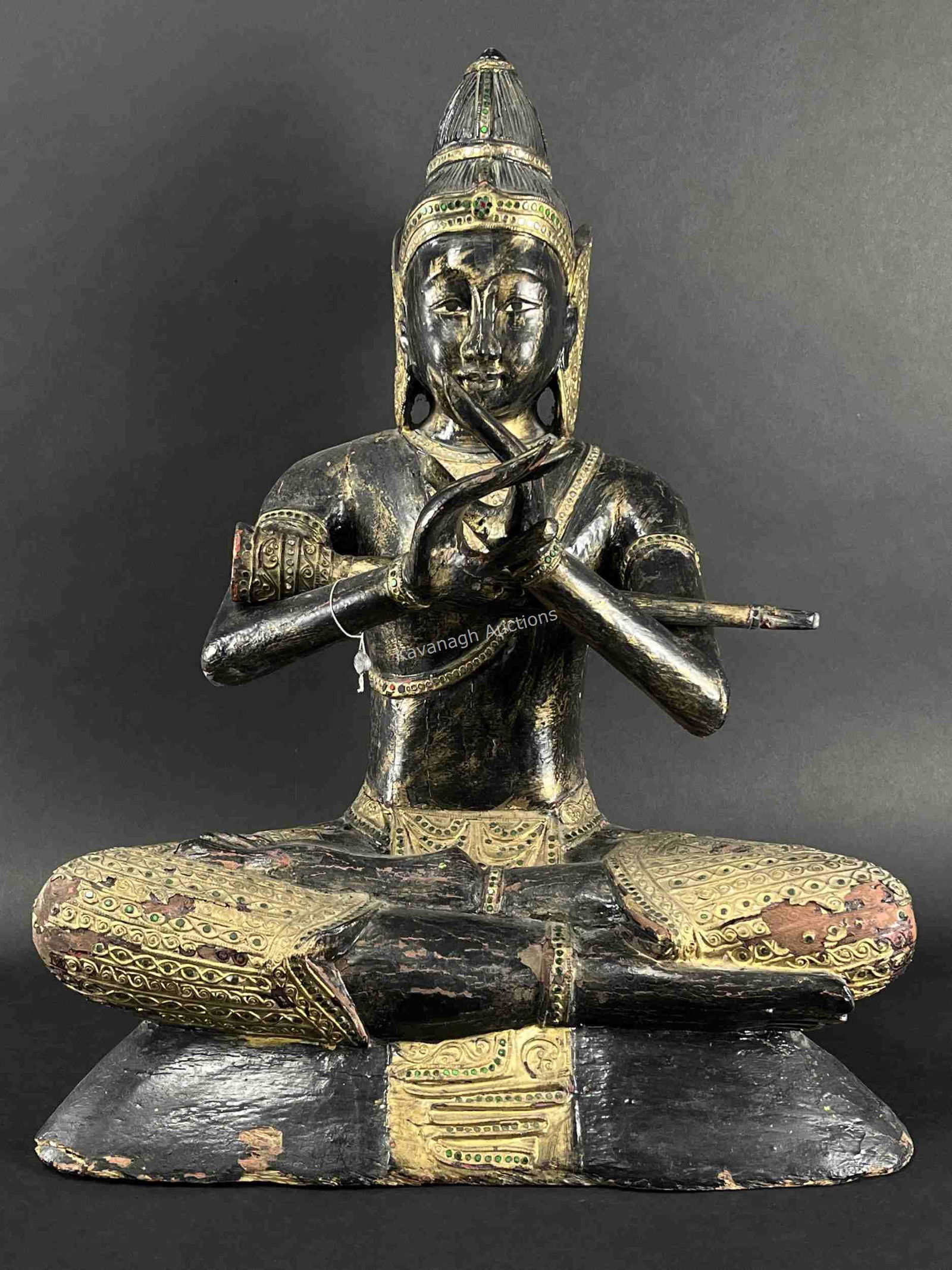 Thai Antique Carved Ebony Buddha Playing Flute: Thai Antique Carved Ebony Buddha Playing Flute. Parcel Gilt, Set With Reflective Coloured Foils; With Stamped Export Tag. Areas Of Chipping And Flaking, Please See Photos. 27 Inches H X 21 X 13 Deep.