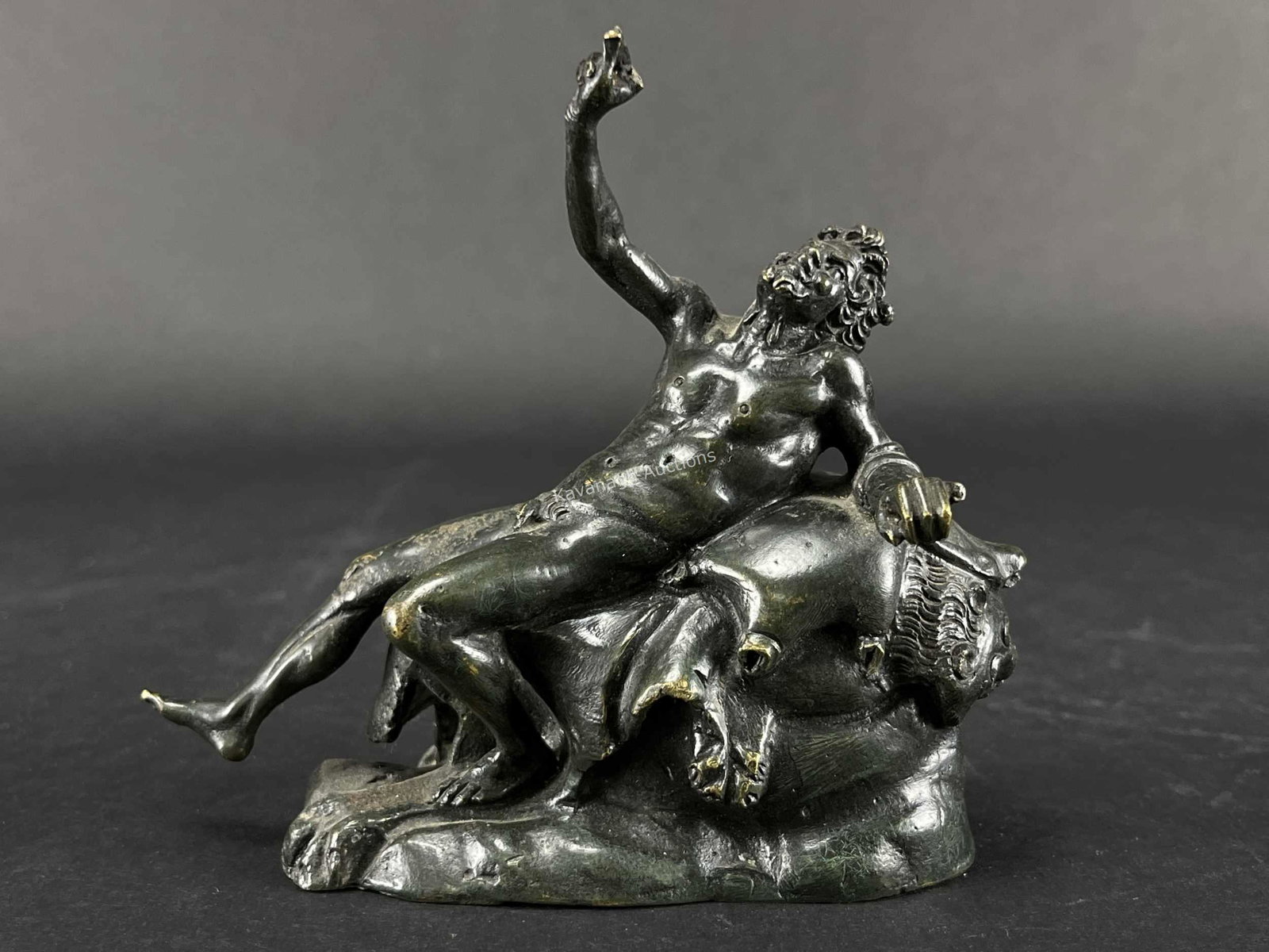 19th C Italy Grand Tour Reclining Bacchus Bronze: 19th C Italy Grand Tour Reclining Bacchus Bronze. Lying on lion skin with wine bag under arm. 5 inches H x 5.5 L.