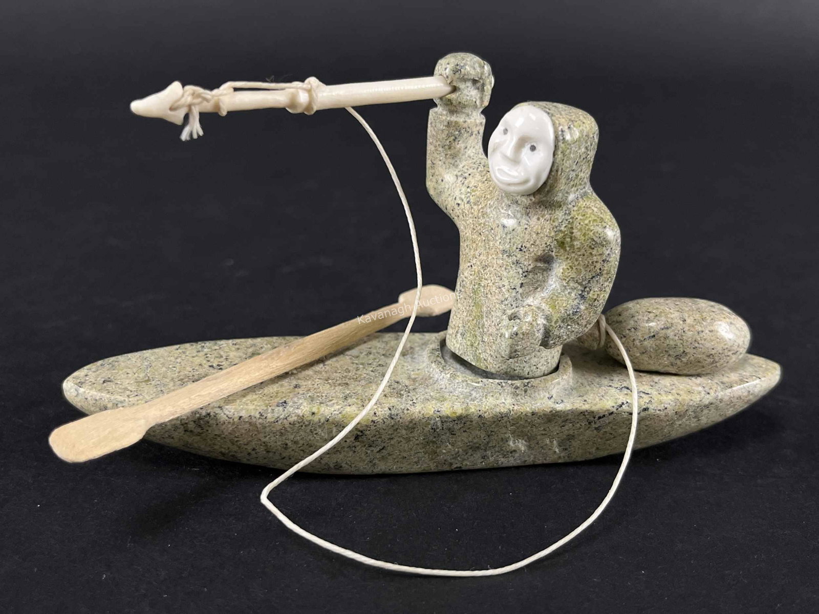 Signed Inuit Soapstone and Bone Hunter in Kayak: Signed Syllabic Inuit Soapstone and Bone Hunter in Kayak. 6 inches L x 3 H. Wood paddle, bone carved spear and face.