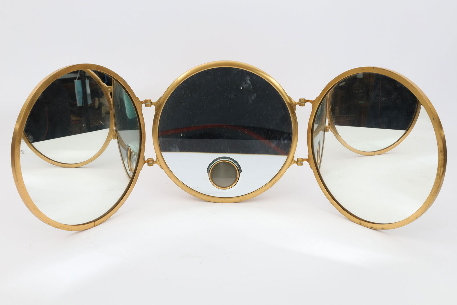 Art Deco French Brot Triptych Illuminated Mirror: Art Deco French Brot Triptych Illuminated Gilt Bronze Vanity Wall Mirror. Each mirror measures 9.5 inches diameter, 28 inches W.