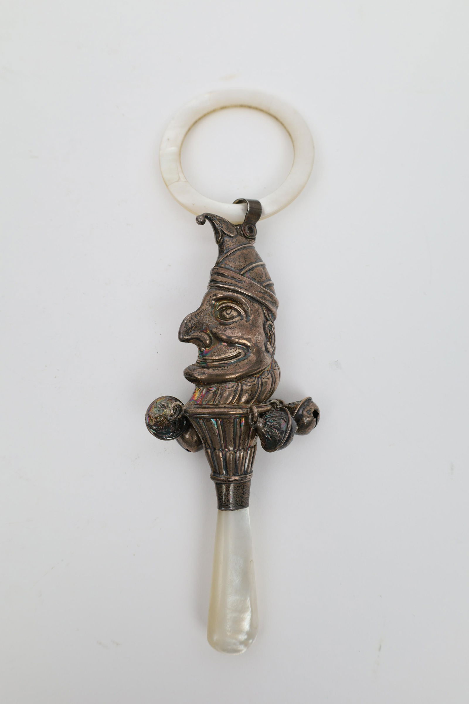 Victorian English Silver Jester Baby Rattle: Victorian English Sterling Silver Jester Baby Rattle with Mother of Pearl Handle and Ring. Hallmarked. 7 inches L, 58 grams total weight.