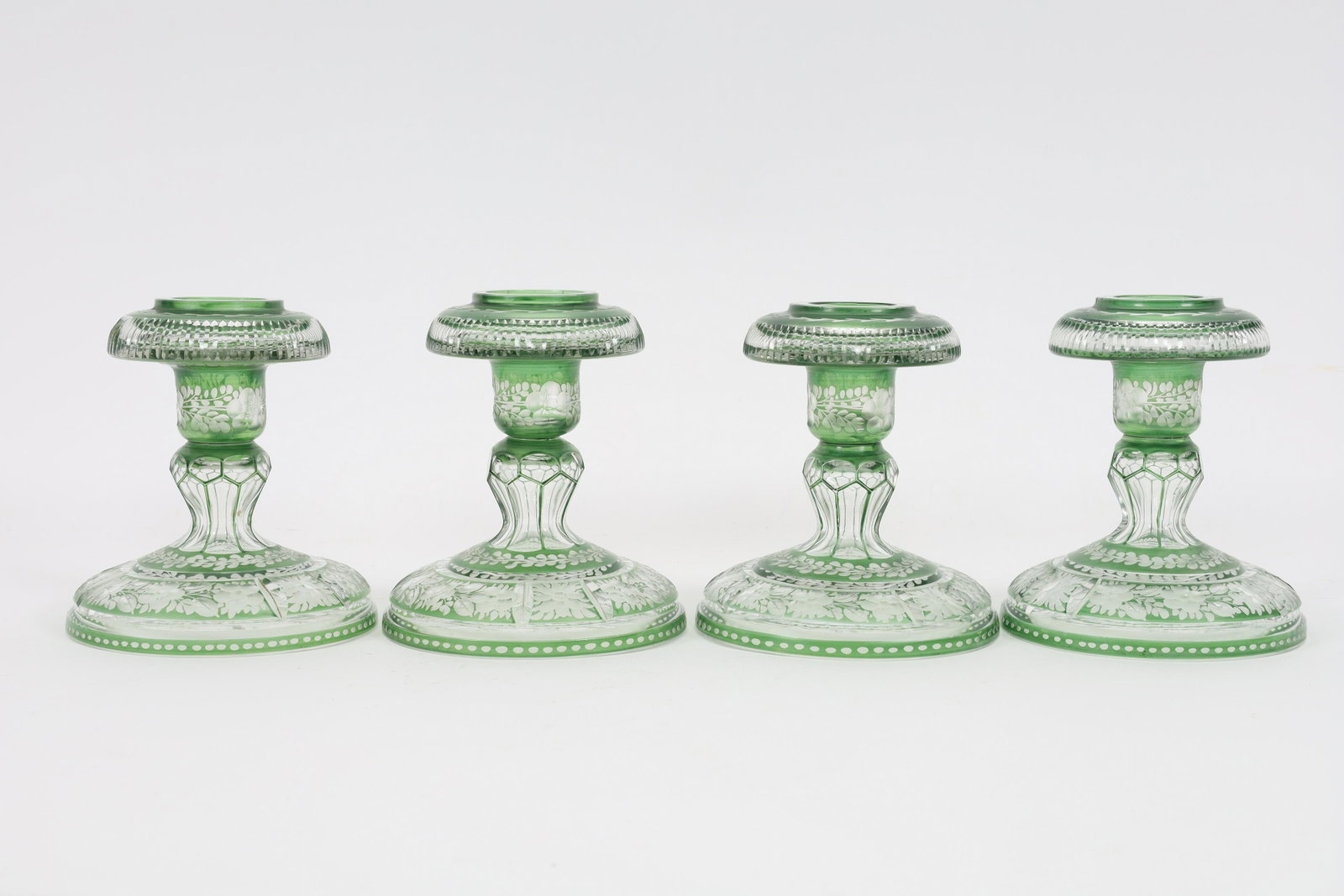 Antique Bohemian Green Cut Crystal Candlesticks: Set of 4 Antique Bohemian Green Cut To Crystal Candlesticks. 5 inches H x 4.5 diameter at the base. No chips or fleabites.