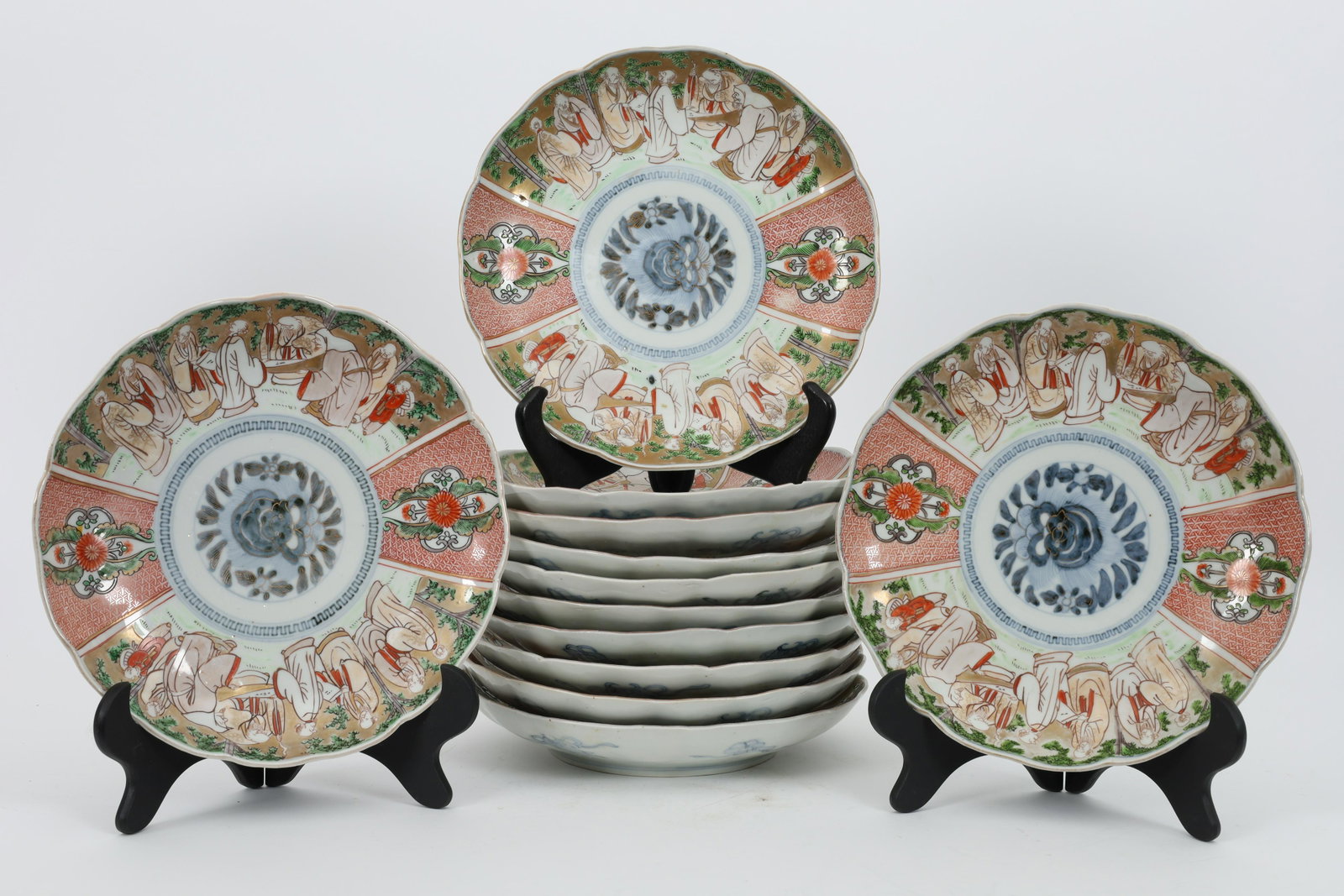 Set of 12 Japanese Imari Scalloped Figural Plates: Set of 12 Japanese Imari Scalloped Figural Plates. 2 with chips. 9.5 inches diameter.