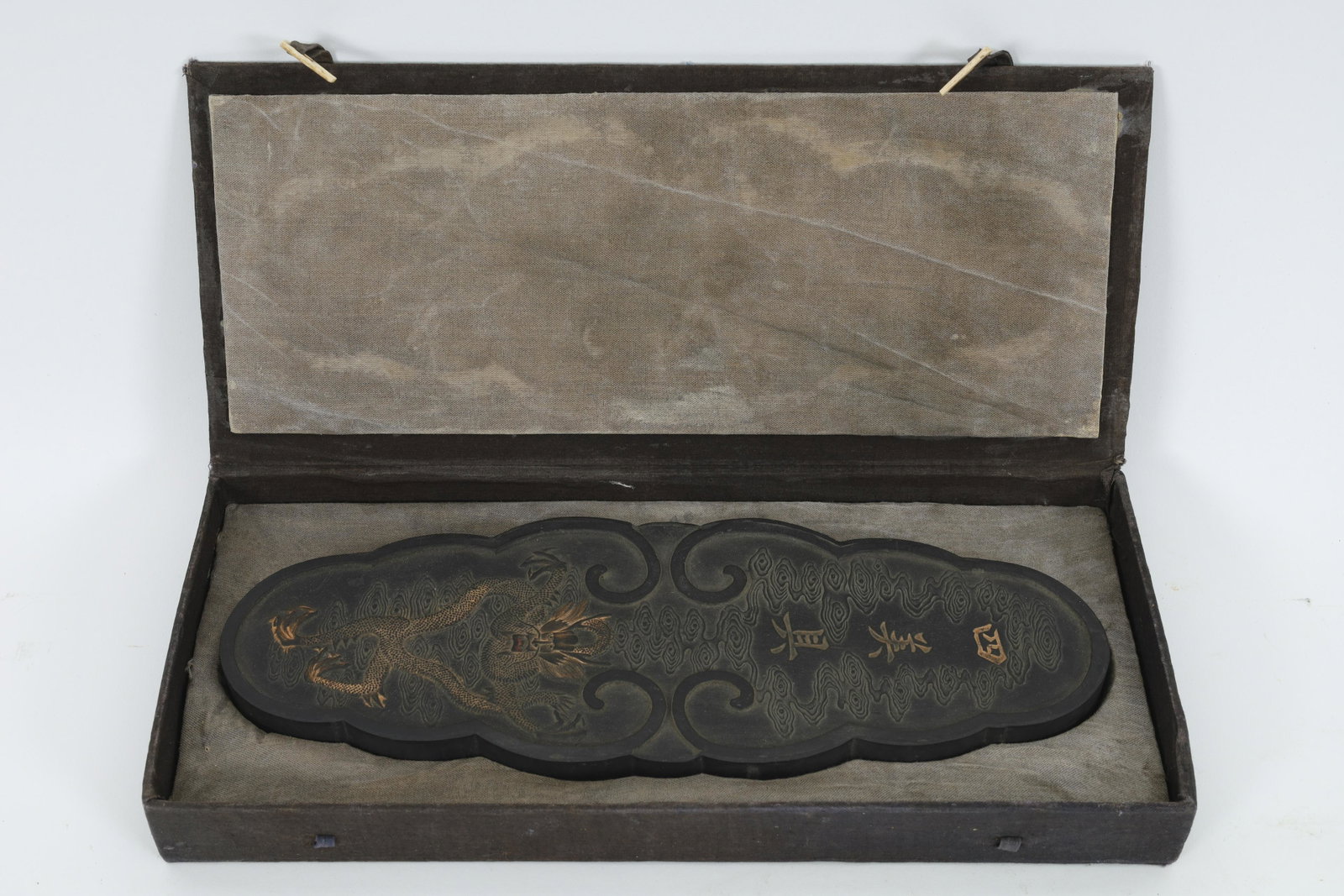 Chinese Large Gilt Inkstone: Chinese Large Gilt Inkstone. Decorated with dragons and beasts, signed on reverse. Measures 11 x 4 inches.