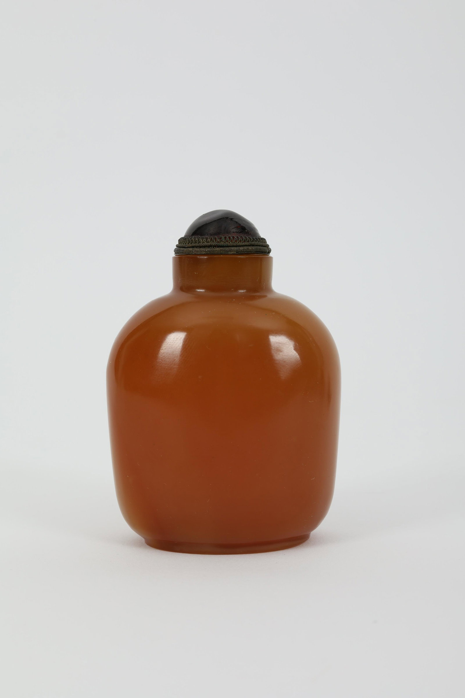 Antique Chinese Mottled Amber Glass Snuff Bottle: Antique Chinese mottled amber coloured glass snuff bottle with red and white striations. 3 inches H.