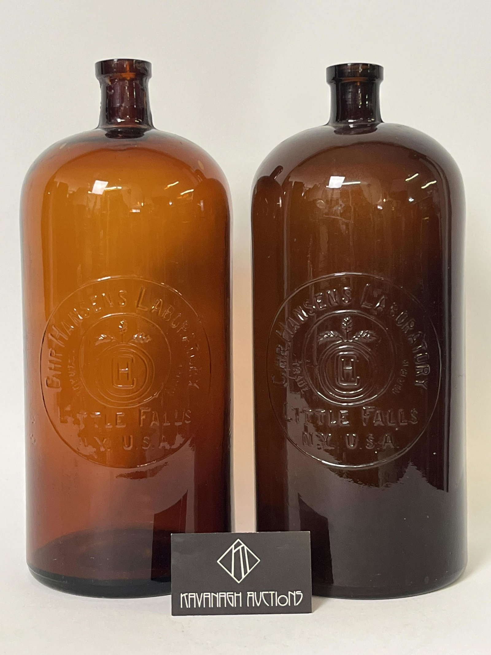 Pair Large Glass Apothecary Laboratory Bottles: Pair Large Amber Glass Apothecary Laboratory Bottles. Marked in glass Chr Hansens Laboratory. 14 inches H.