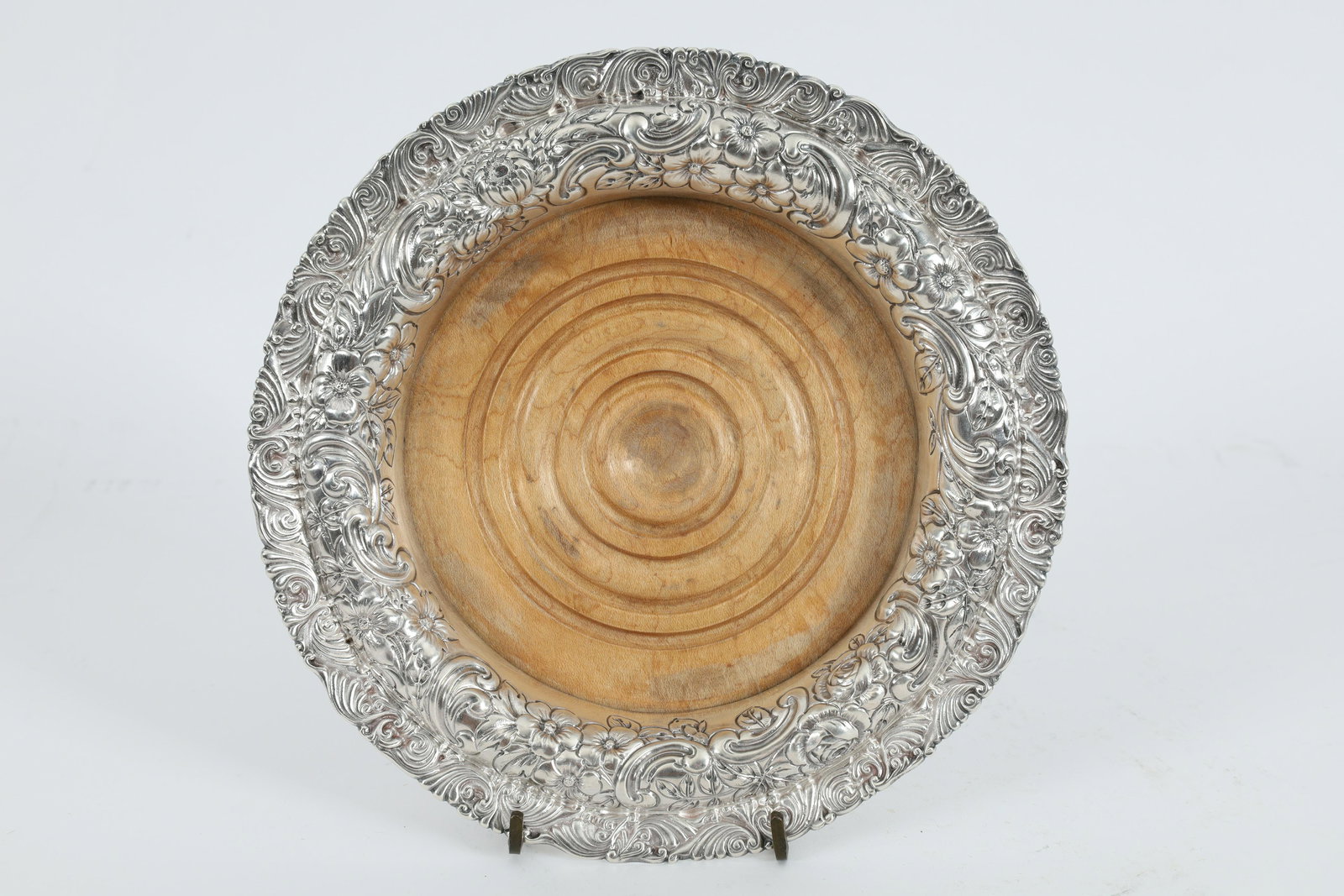 Gorham Sterling Repousse Wine Bottle Coaster: Victorian American Gorham Silver Company sterling decanter or wine bottle coaster with highly decorative scroll and floral repousse edges, inset with turned wooden base, marked on lower rim with monog
