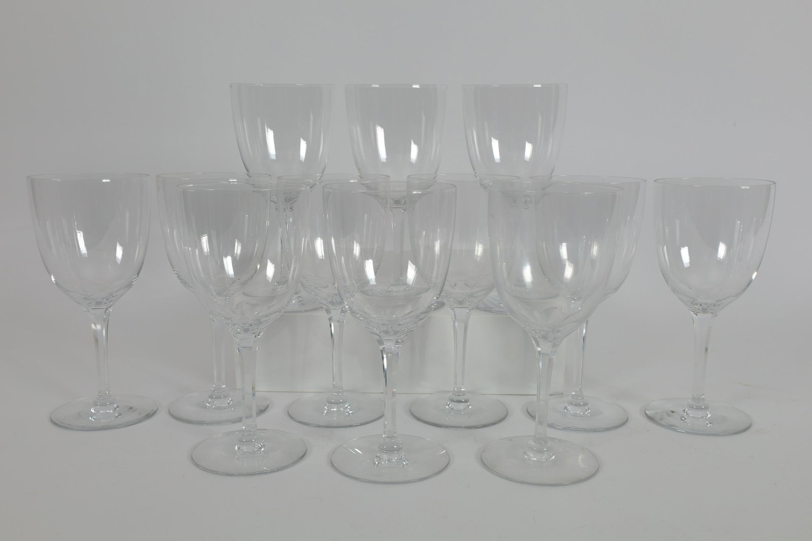 Set of 12 Baccarat Style Cut Crystal Wine Glasses: Set of 12 Baccarat Style Beveled Stem Cut Crystal Wine Glasses. 7 inches H. One fleabite.