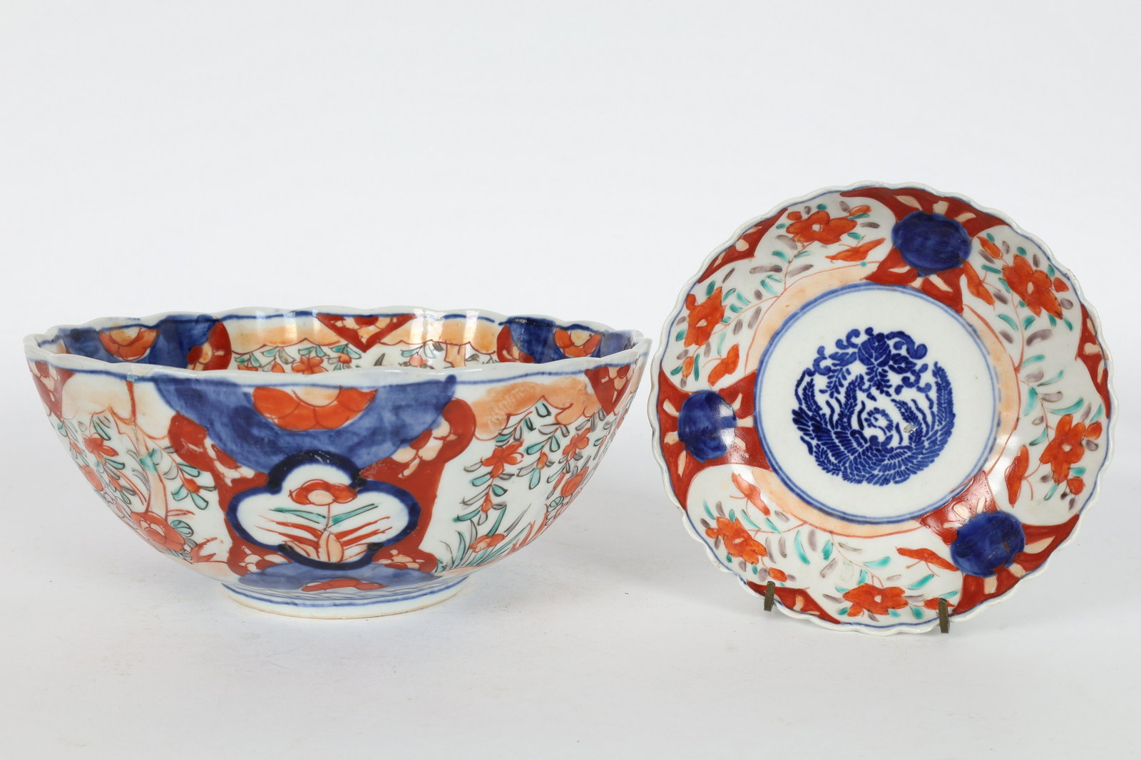Lot Antique Japanese Imari Scalloped Phoenix Bowls: Lot of Antique Japanese Imari Bowls decorated with Phoenixes in centres. Hairline crack to large bowl, small restoration to rim. Please see photos. Large bowl measures 8.5 x 3.5 inches H, small bowl m