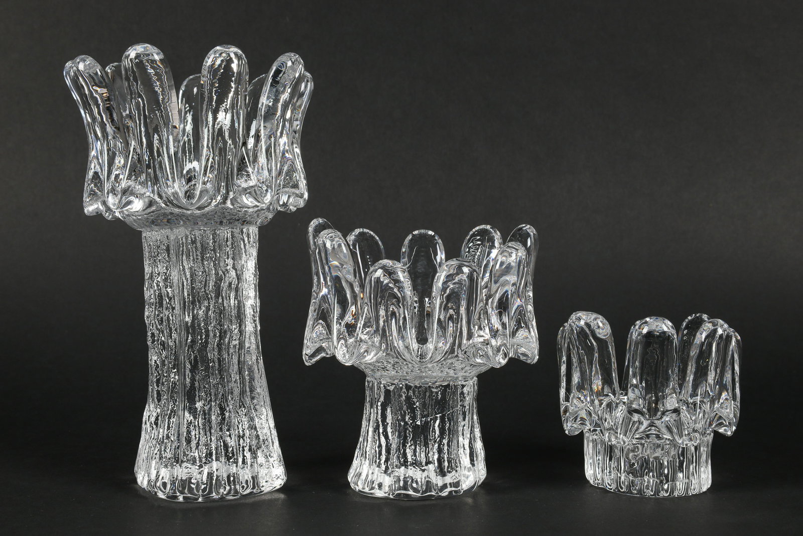 Set Kosta Boda Goran Warff Sunflower Candleholders: Set of 3 Kosta Boda Goran Warff Sunflower Candleholders. Tallest measures 7 inches H x 4.5 diameter.