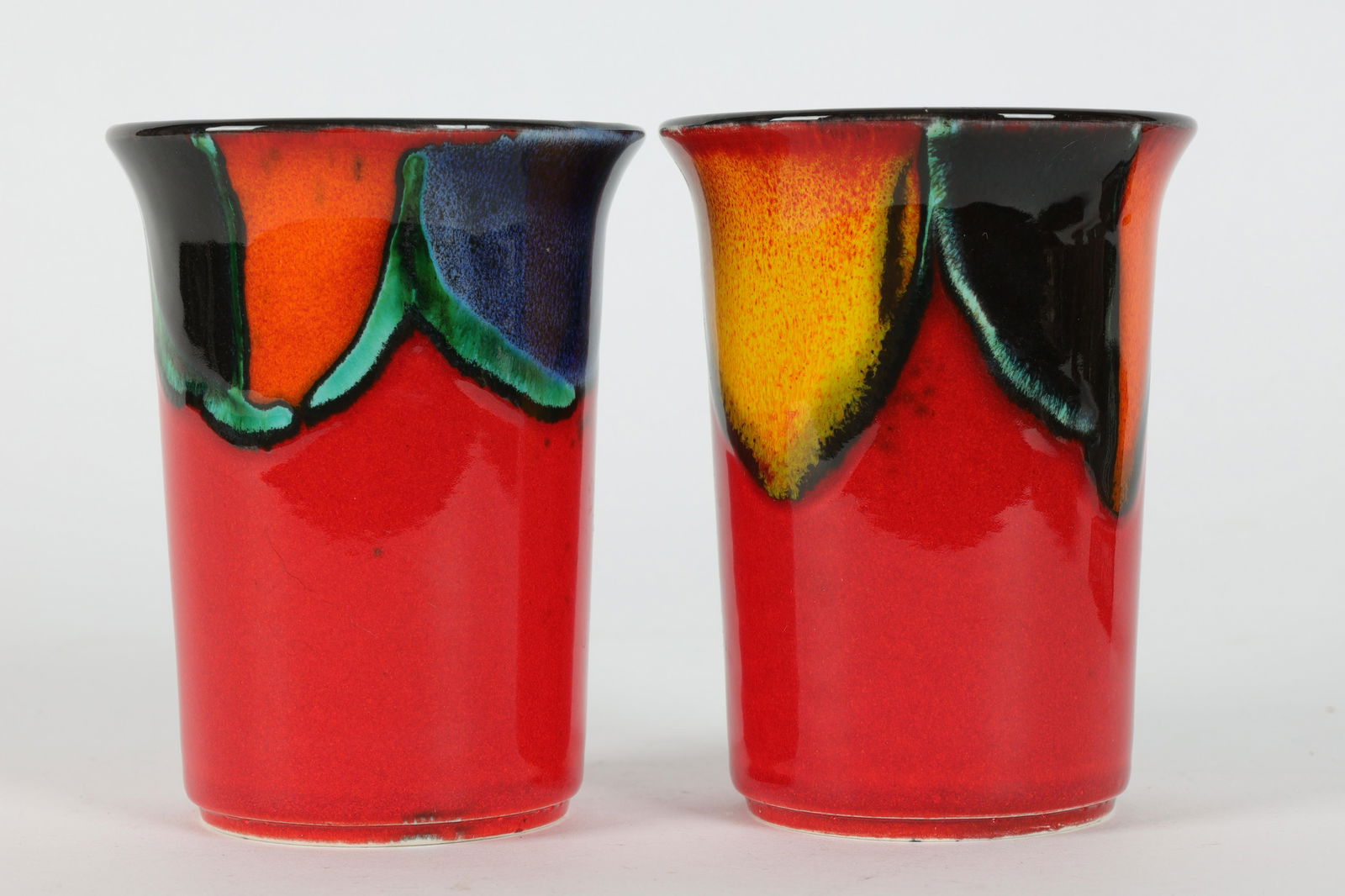 Pair of 1980s Poole Pottery England Red Tumblers: Pair of 1980s Poole Pottery England Abstract Red Tumblers. Measure 3 inches diameter x 3.75 H. Signed on base with a fish.